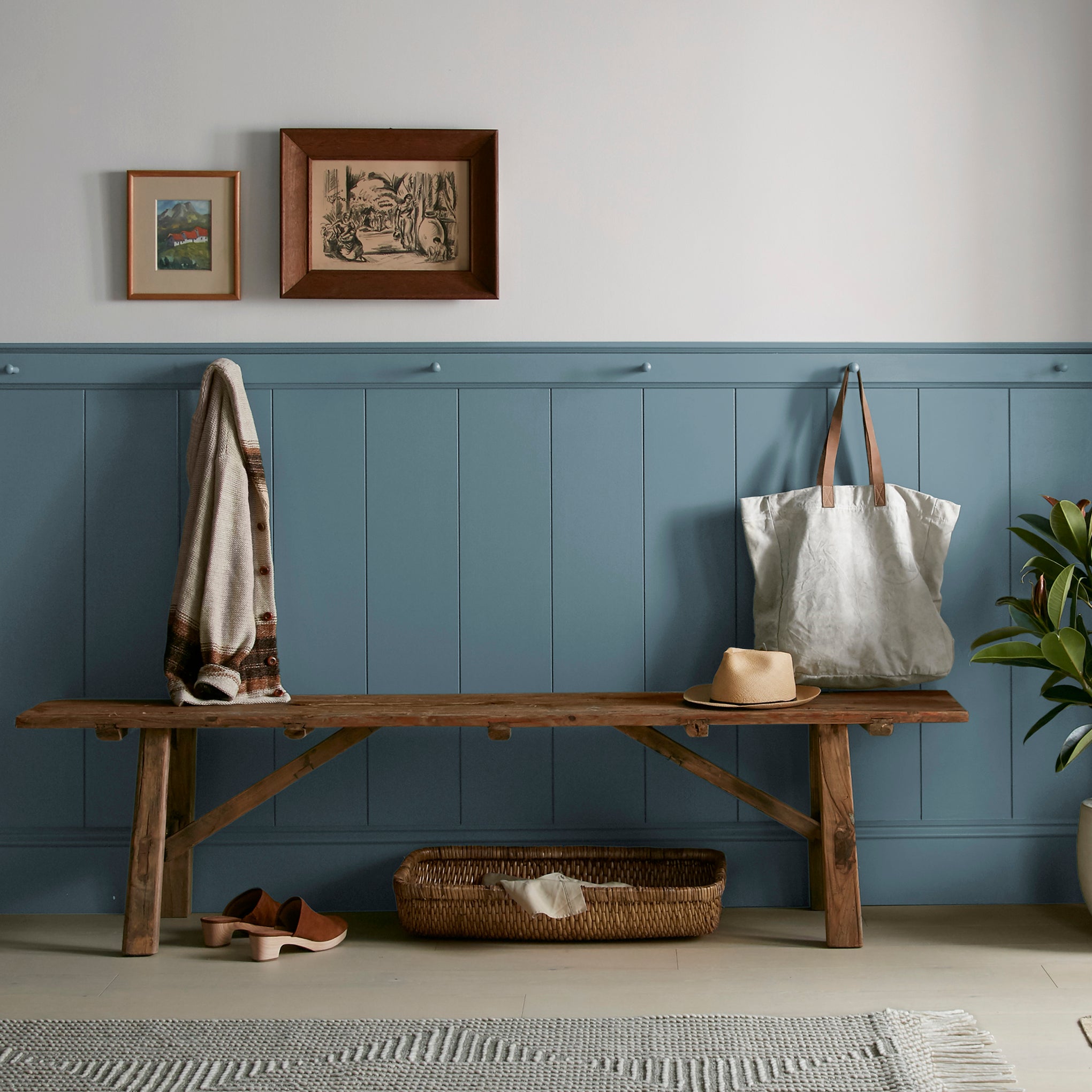 deep steel blue with grey undertone paint named blue skies shown painted on entryway wall