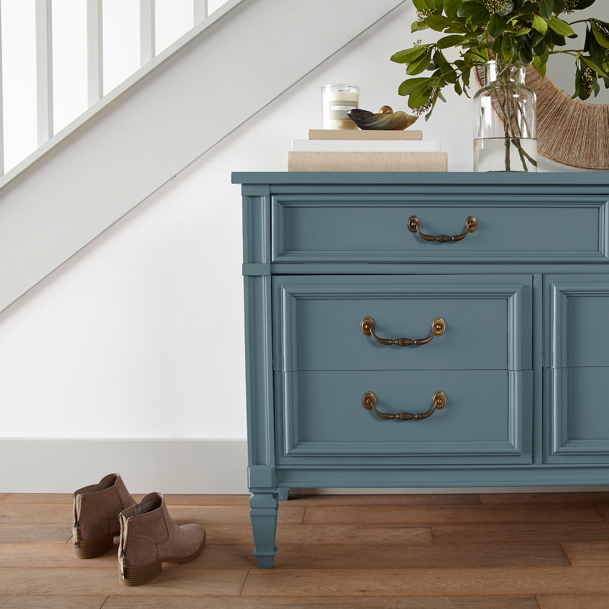 Deep steely blue door and cabinet paint named blue skies shown painted on entryway cabinet