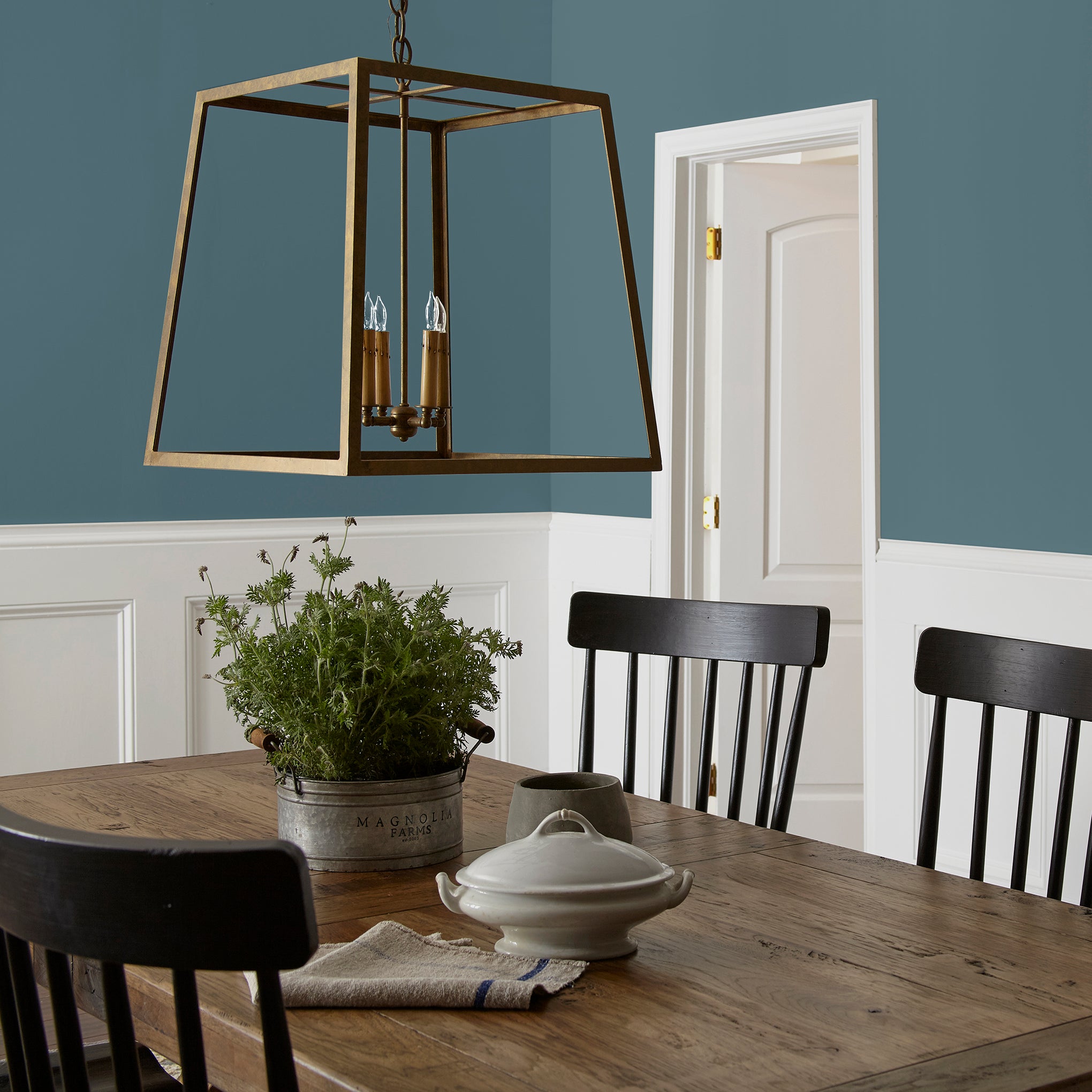 Denim blue slightly muted with gray and silver hues interior paint named bright future shown painted on dining room wall
