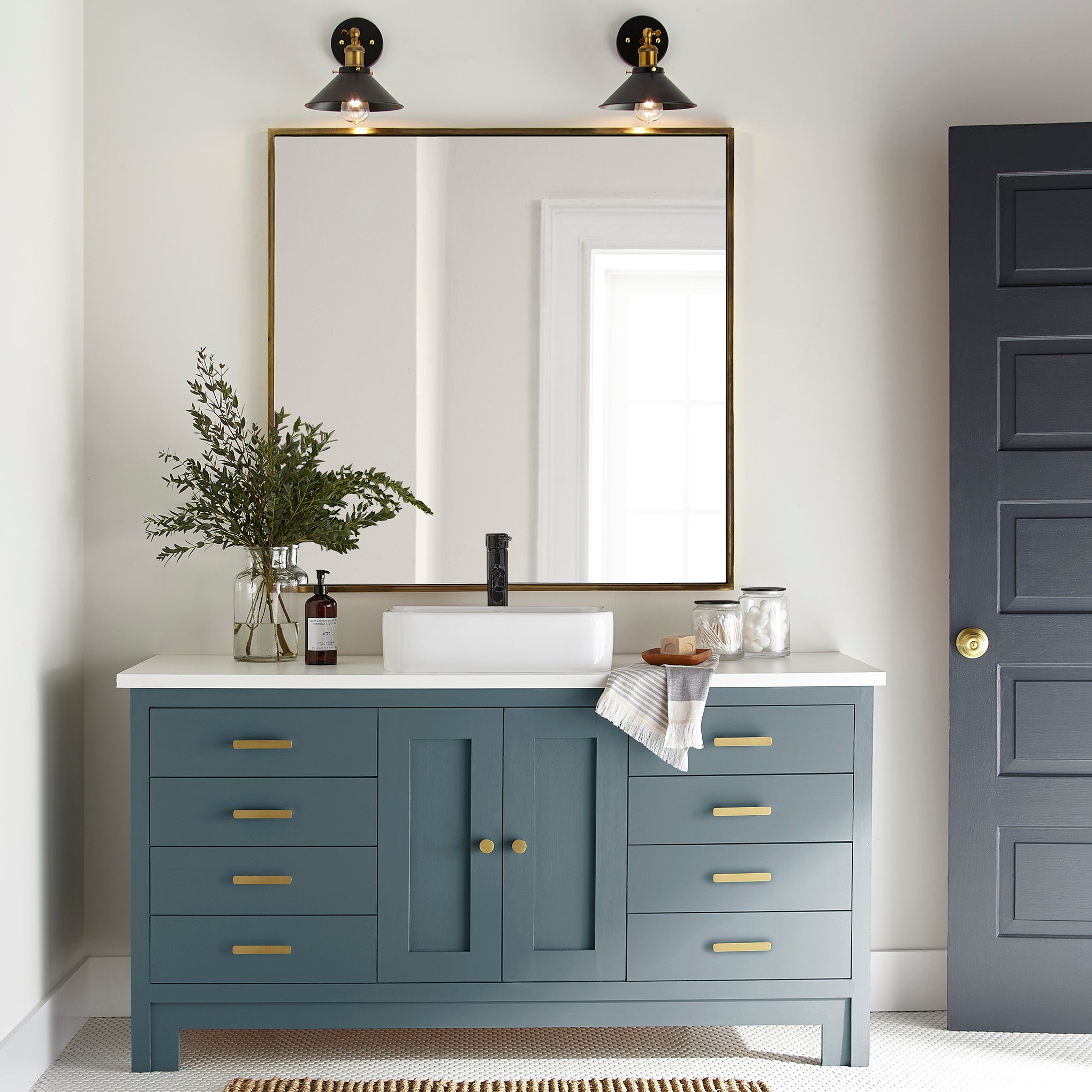 Denim blue slightly muted with gray and silver hues door and cabinet paint named bright future shown painted on bathroom cabinet