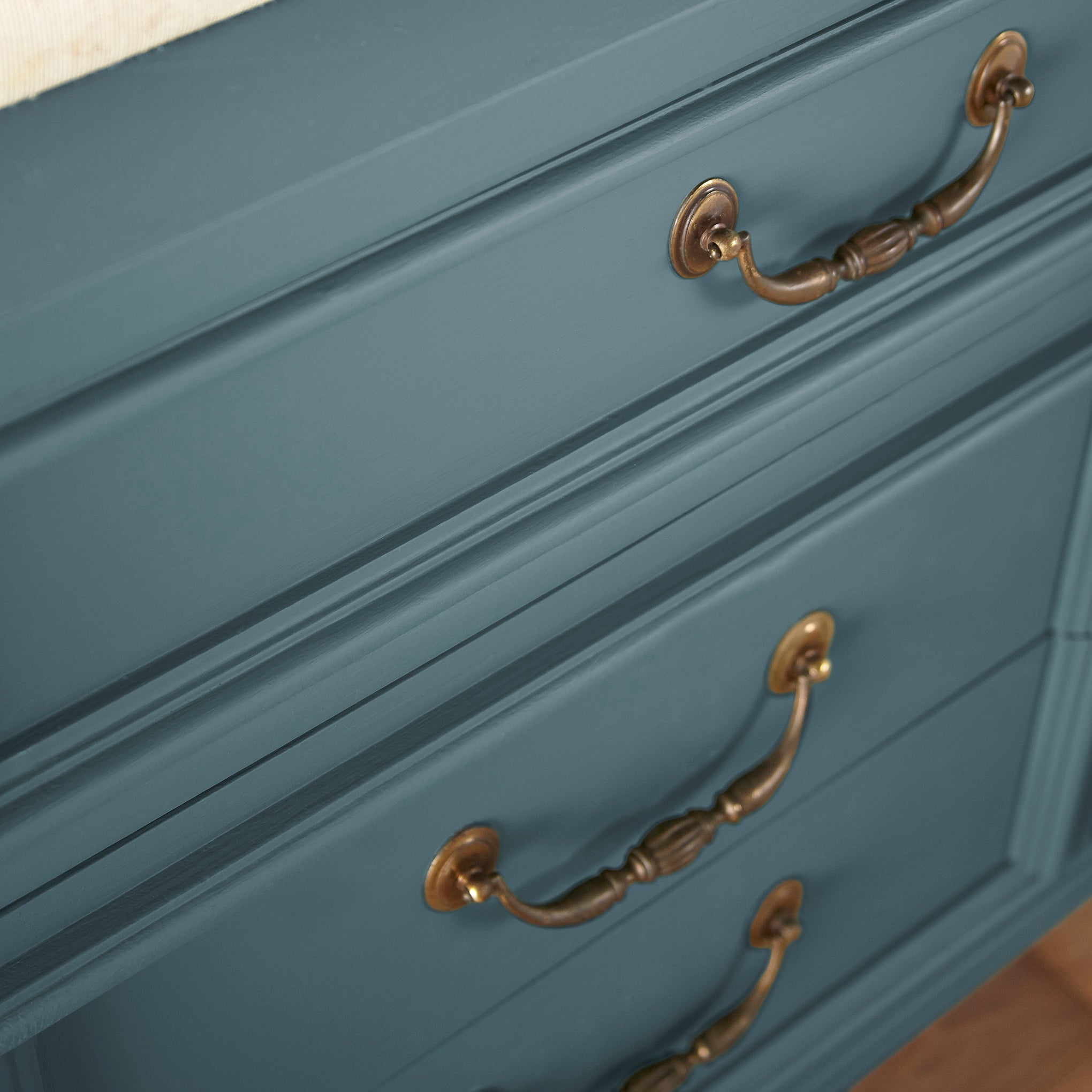 Denim blue slightly muted with gray and silver hues door and cabinet paint named bright future shown painted on cabinet