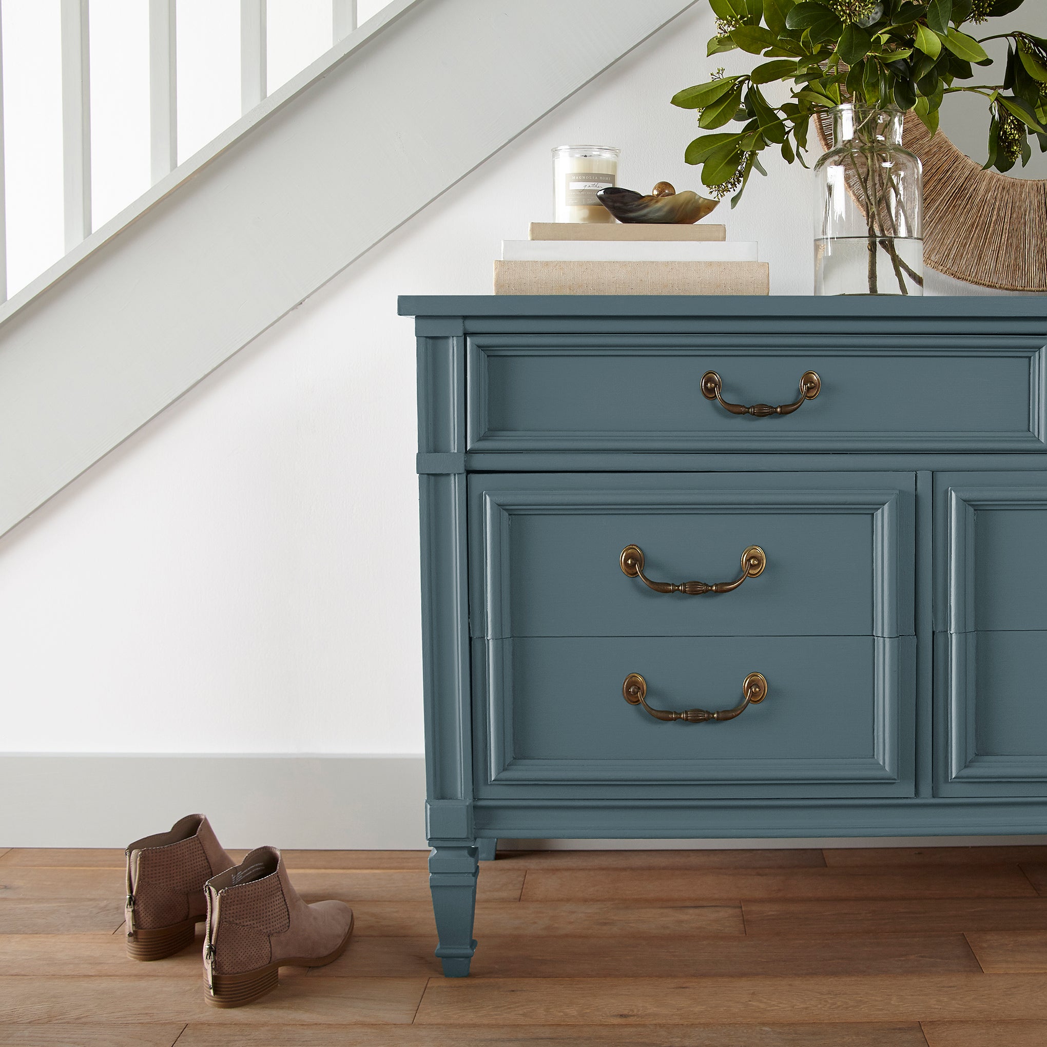 Denim blue slightly muted with gray and silver hues door and cabinet paint named bright future shown painted on entryway cabinet
