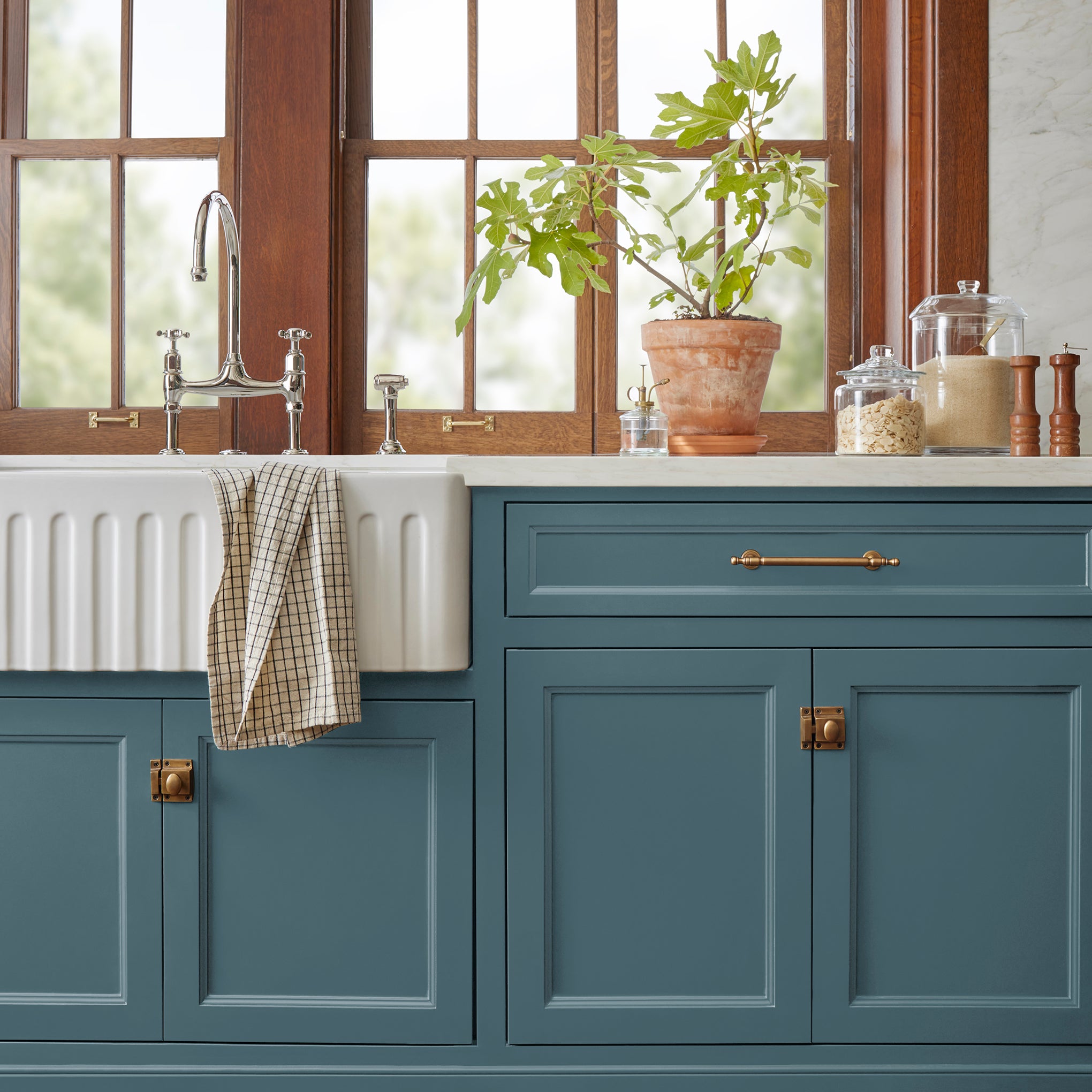 Denim blue slightly muted with gray and silver hues door and cabinet paint named bright future shown painted on kitchen cabinet  