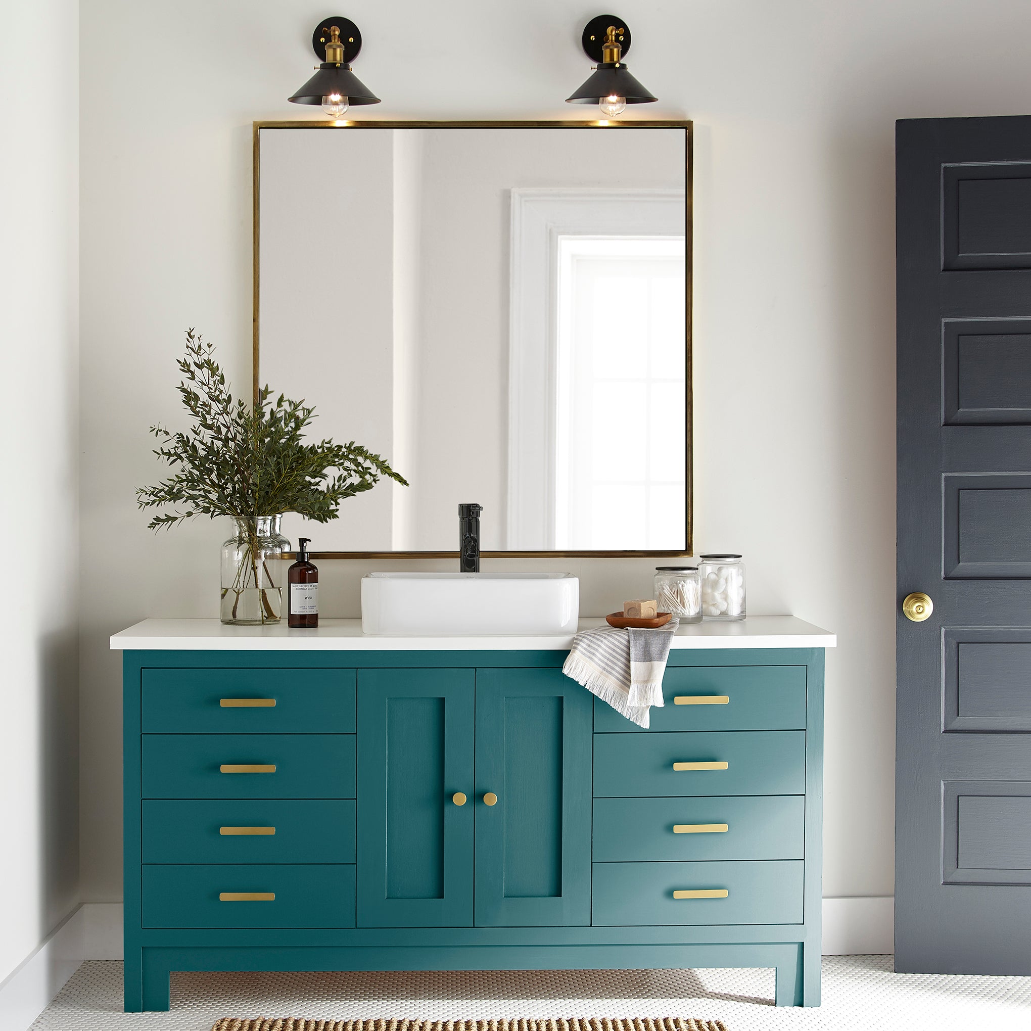 A deep peacock blue door and cabinet paint named under the stars shown painted on bathroom cabinet
