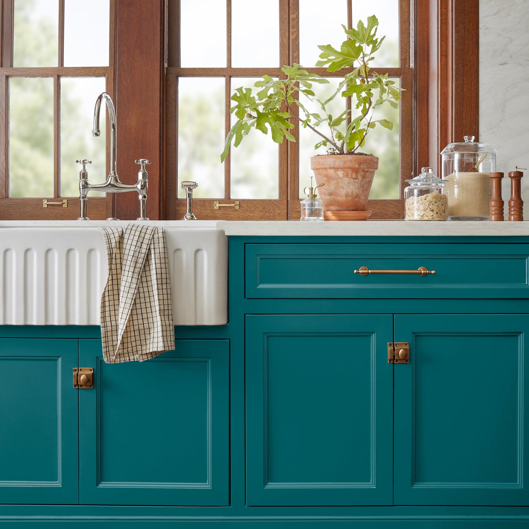 A deep peacock blue door and cabinet paint named under the stars shown painted on kitchen cabinet  