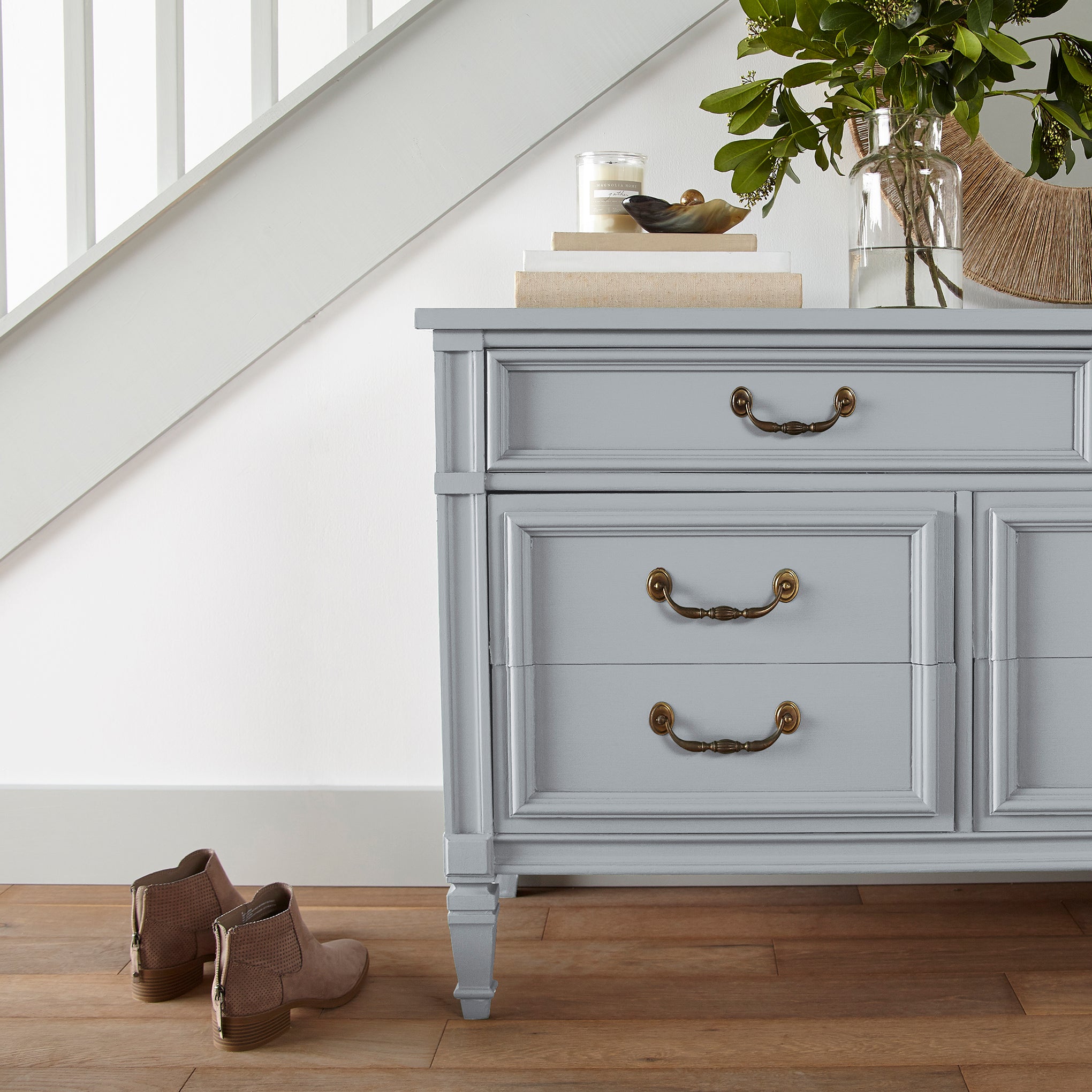 Soft cool gray door and cabinet paint named cement pots shown painted on entryway cabinet
