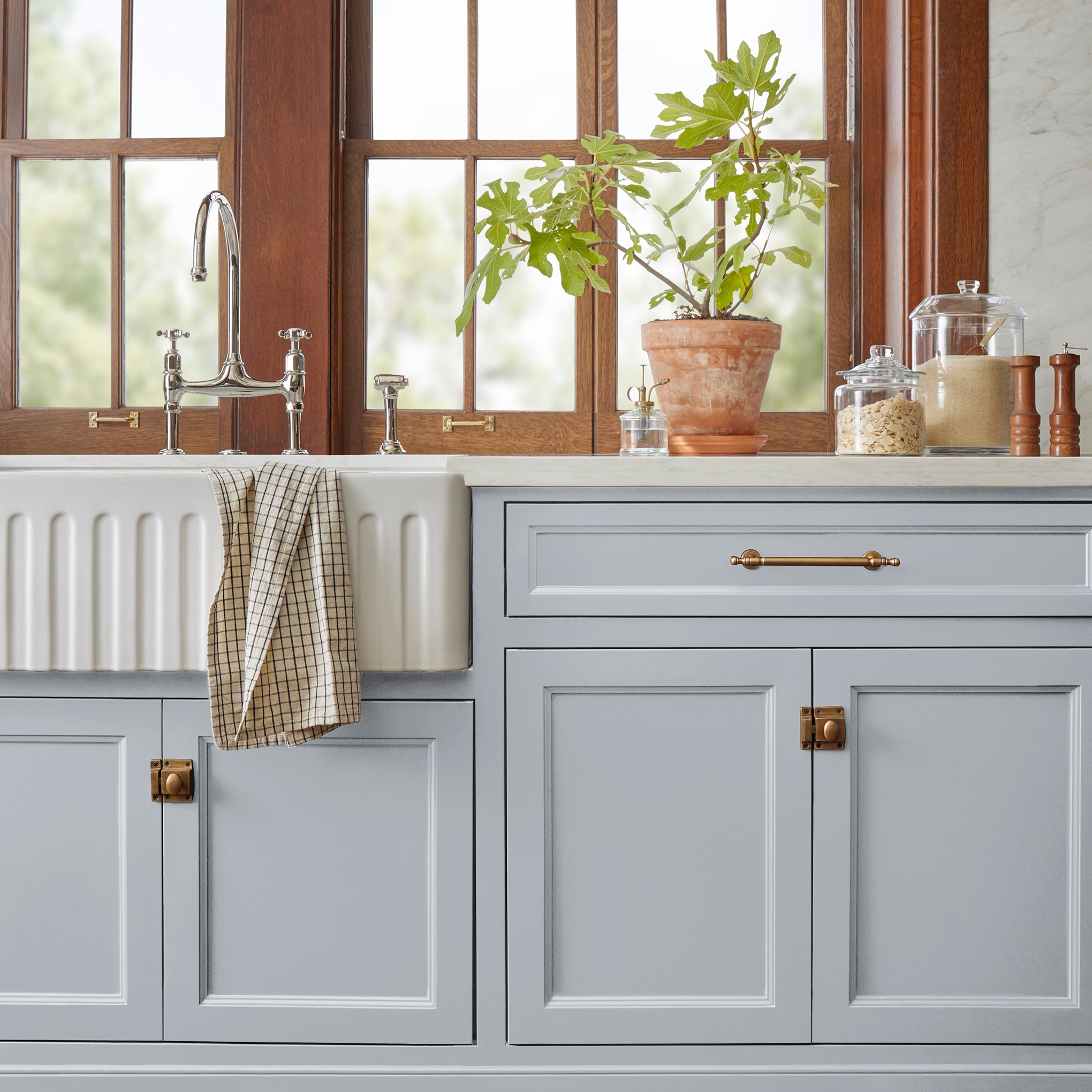 Soft cool gray door and cabinet paint named cement pots shown painted on kitchen cabinet  