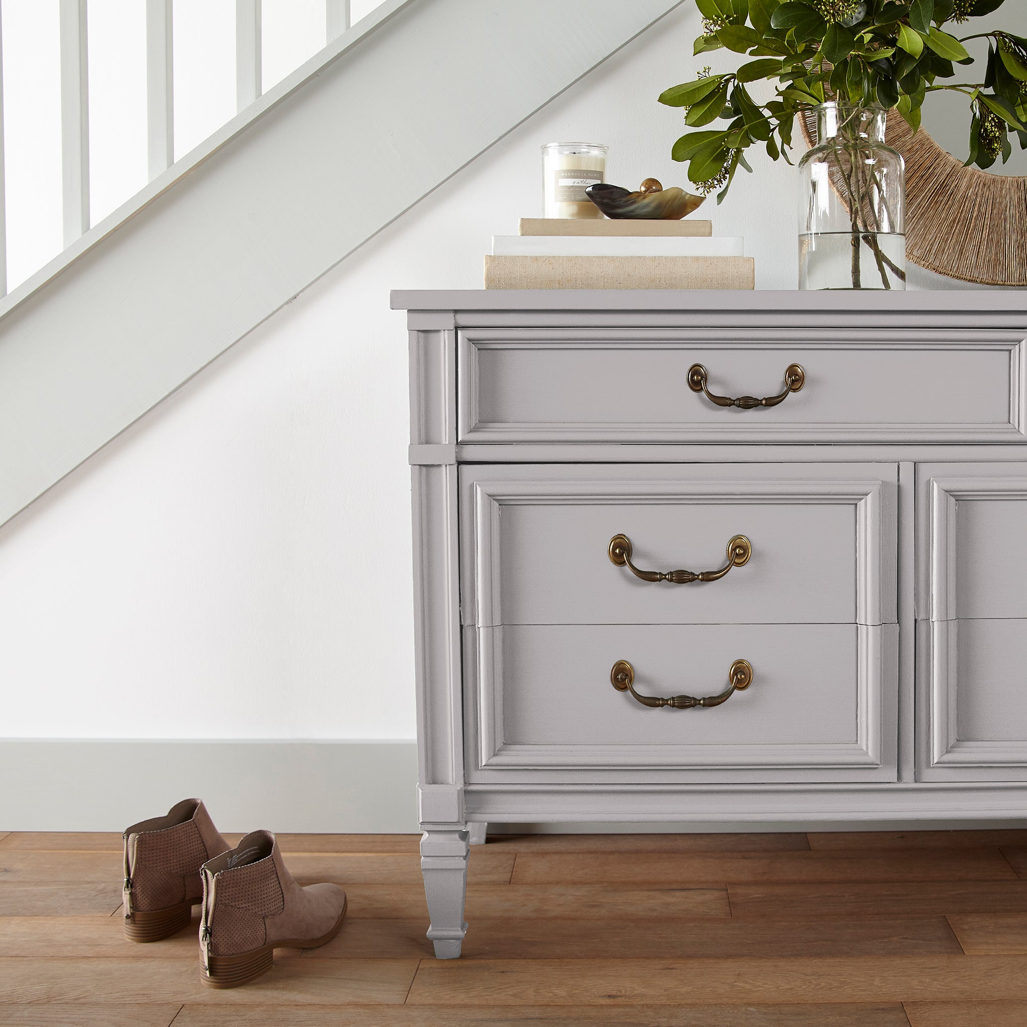 A muted lavender door and cabinet paint named in bloom shown painted on entryway cabinet