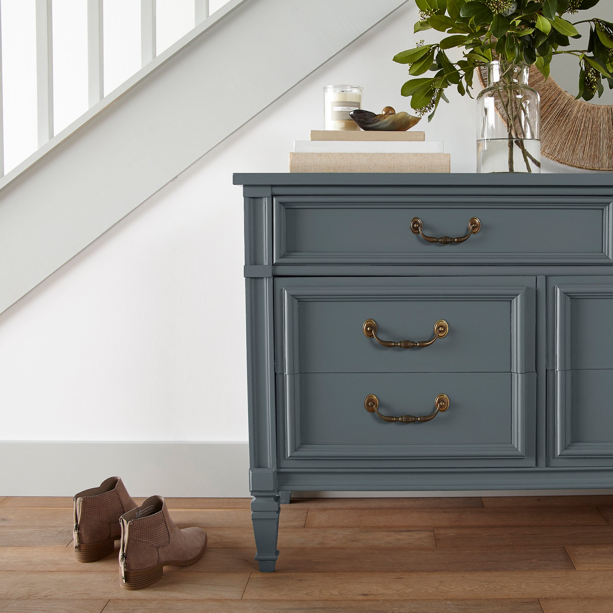 A dark smoky gray with blue undertones door and cabinet paint named coffee nook shown painted on entryway cabinet