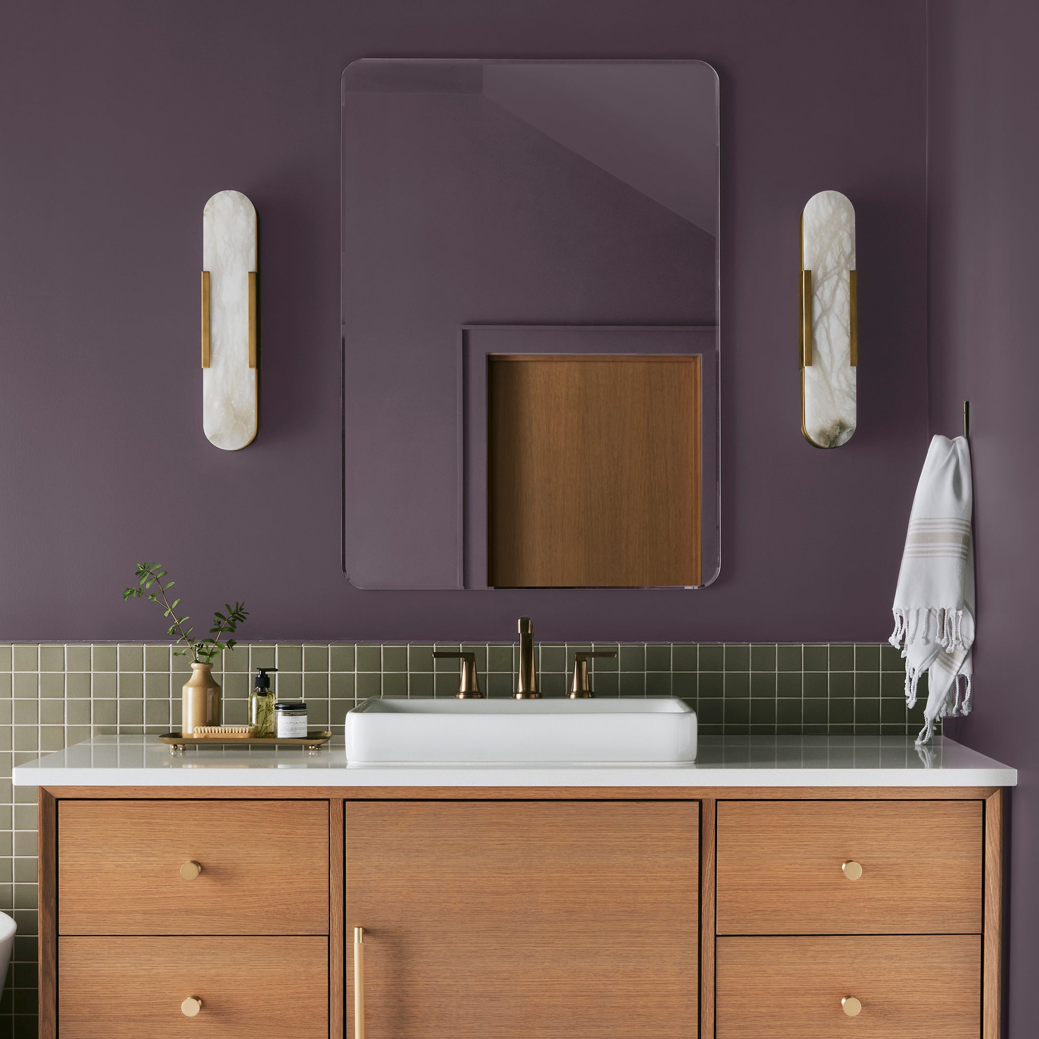 Deep eggplant purple interior paint named plum suede shown painted on bathroom wall