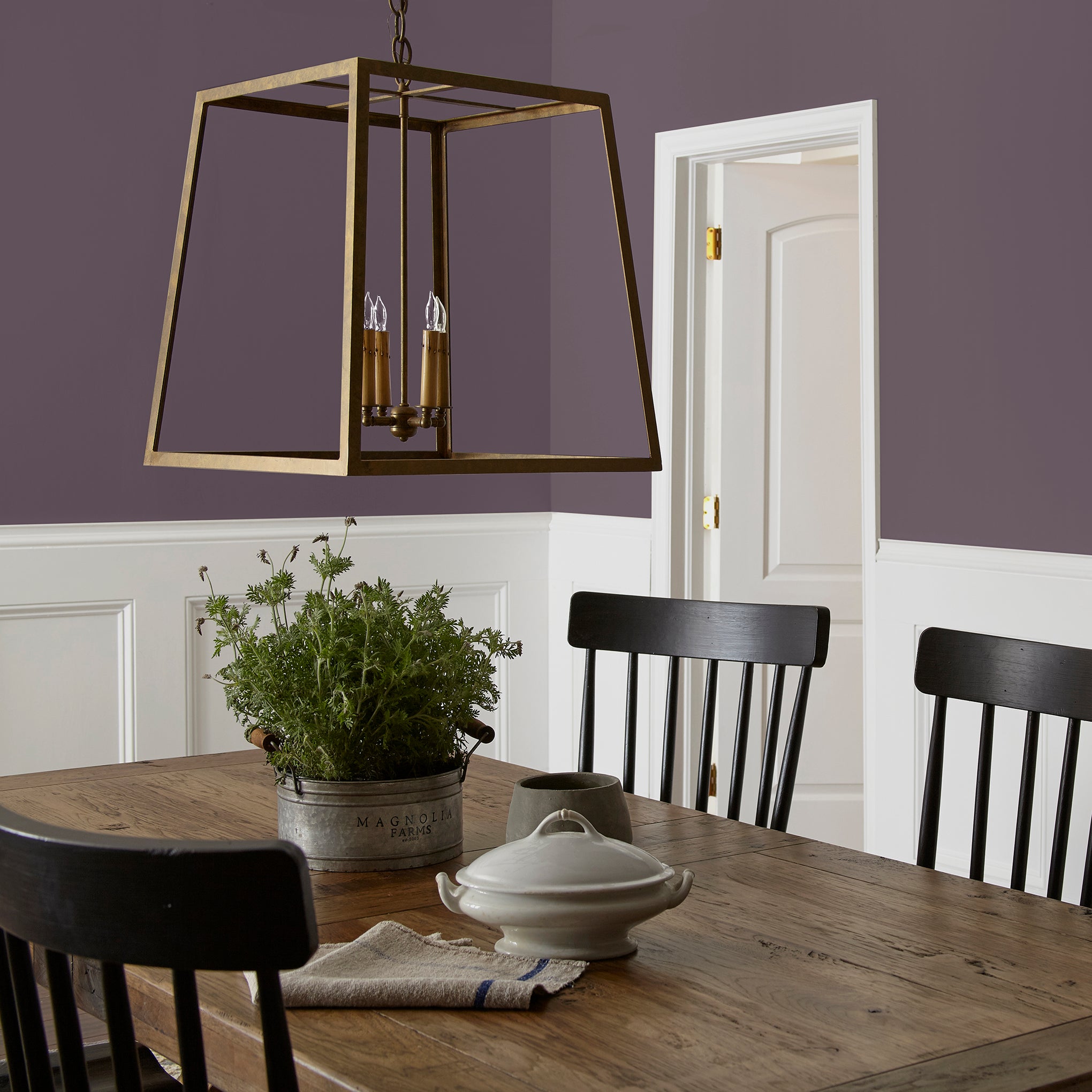 Deep eggplant purple interior paint named plum suede shown painted on dining room wall