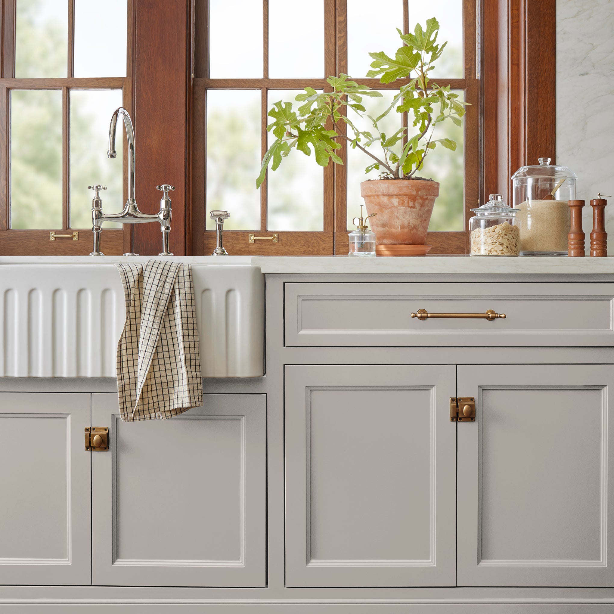 Soft tan with notes of gray door and cabinet paint named anatolian shown painted on kitchen cabinet