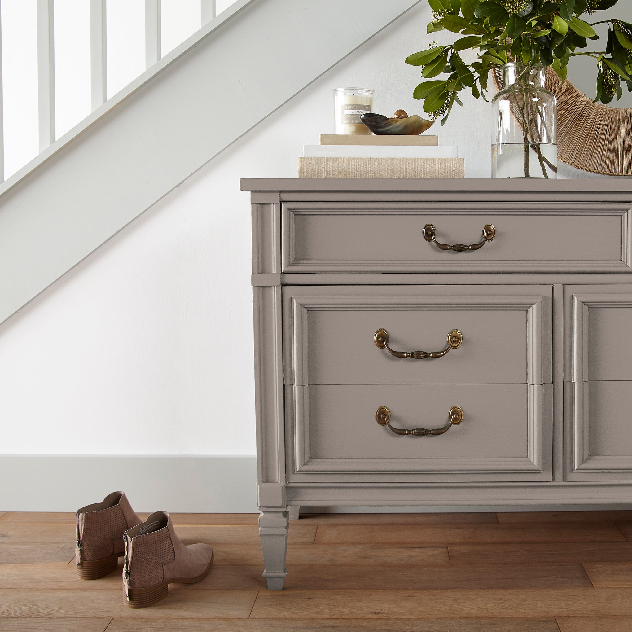 A taupe brown door and cabinet paint named antiquing shown painted on entryway cabinet