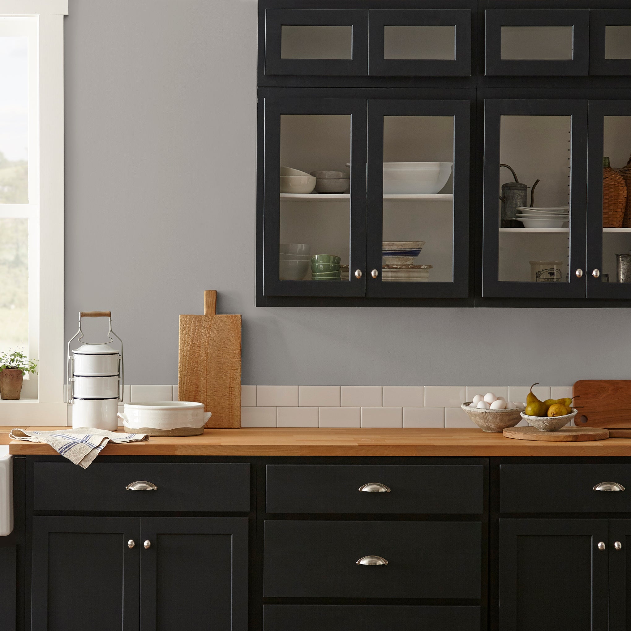 Muted gray with lavender hues interior paint named watering can shown painted on kitchen wall