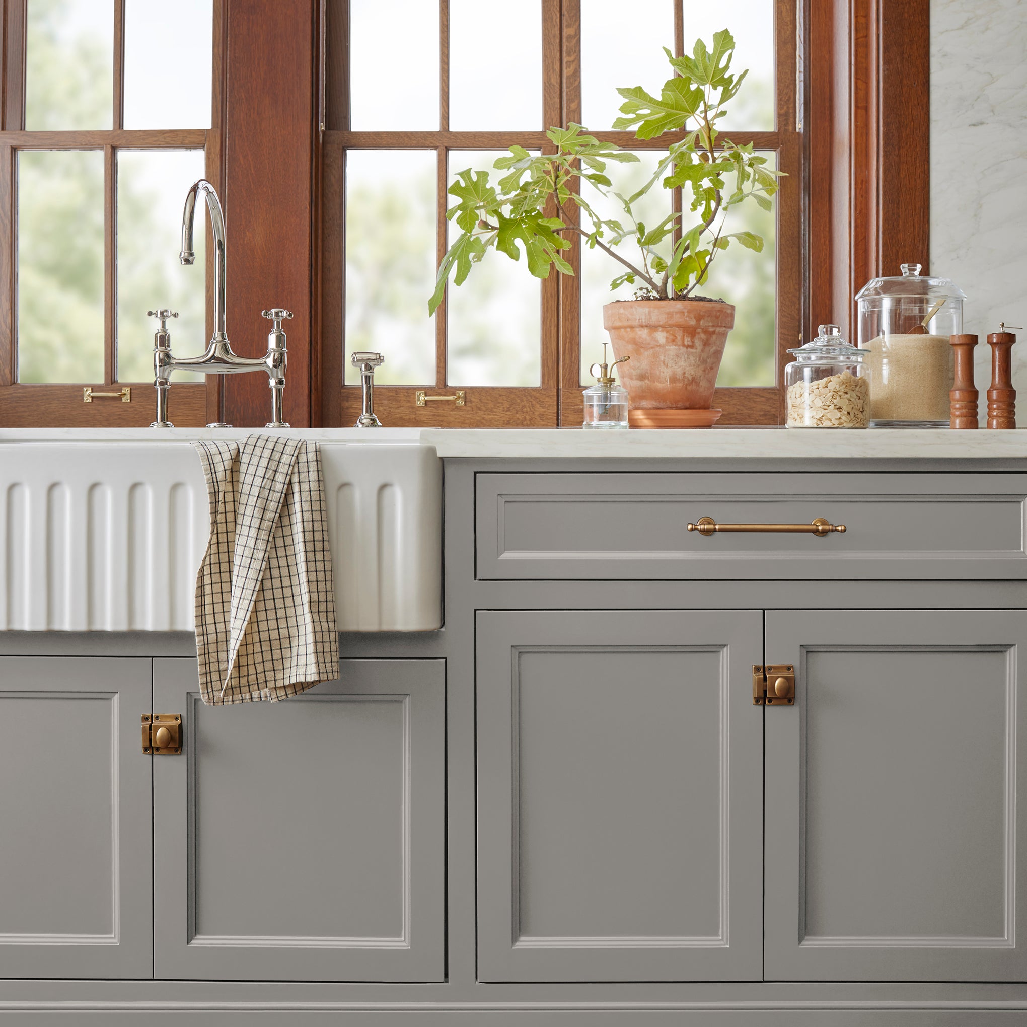 A mousy grayed brown door and cabinet paint named before and after shown painted on kitchen cabinet 