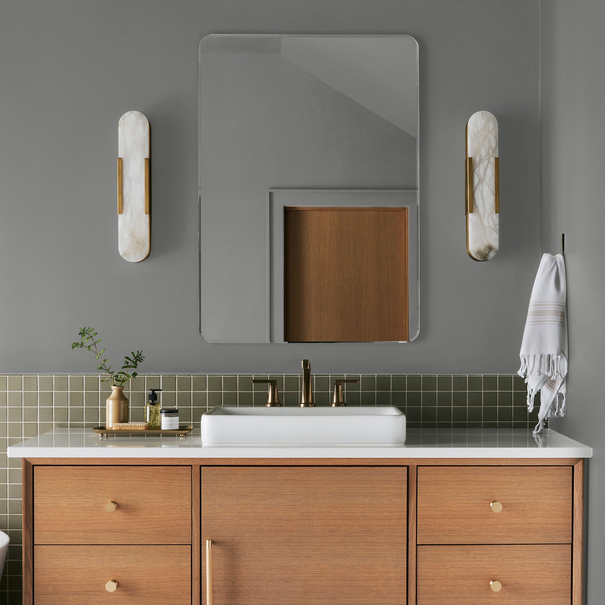 A warm mid-tone gray interior paint named cozy up shown painted on bathroom wall