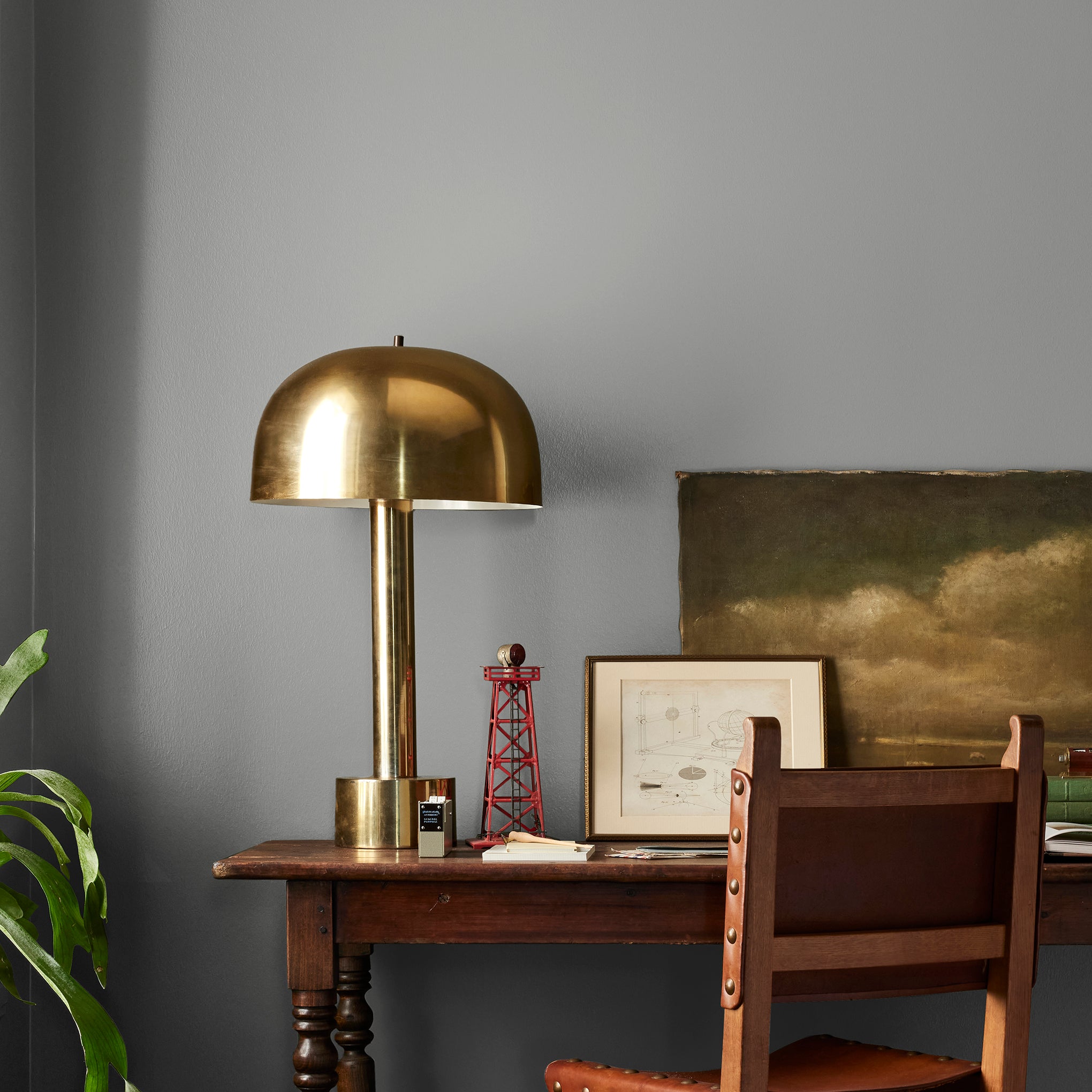 A warm mid-tone gray interior paint named cozy up shown painted on bedroom wall
