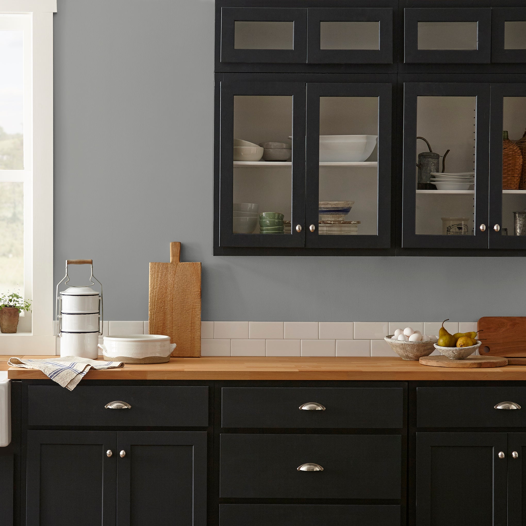 A warm mid-tone gray interior paint named cozy up shown painted on kitchen wall