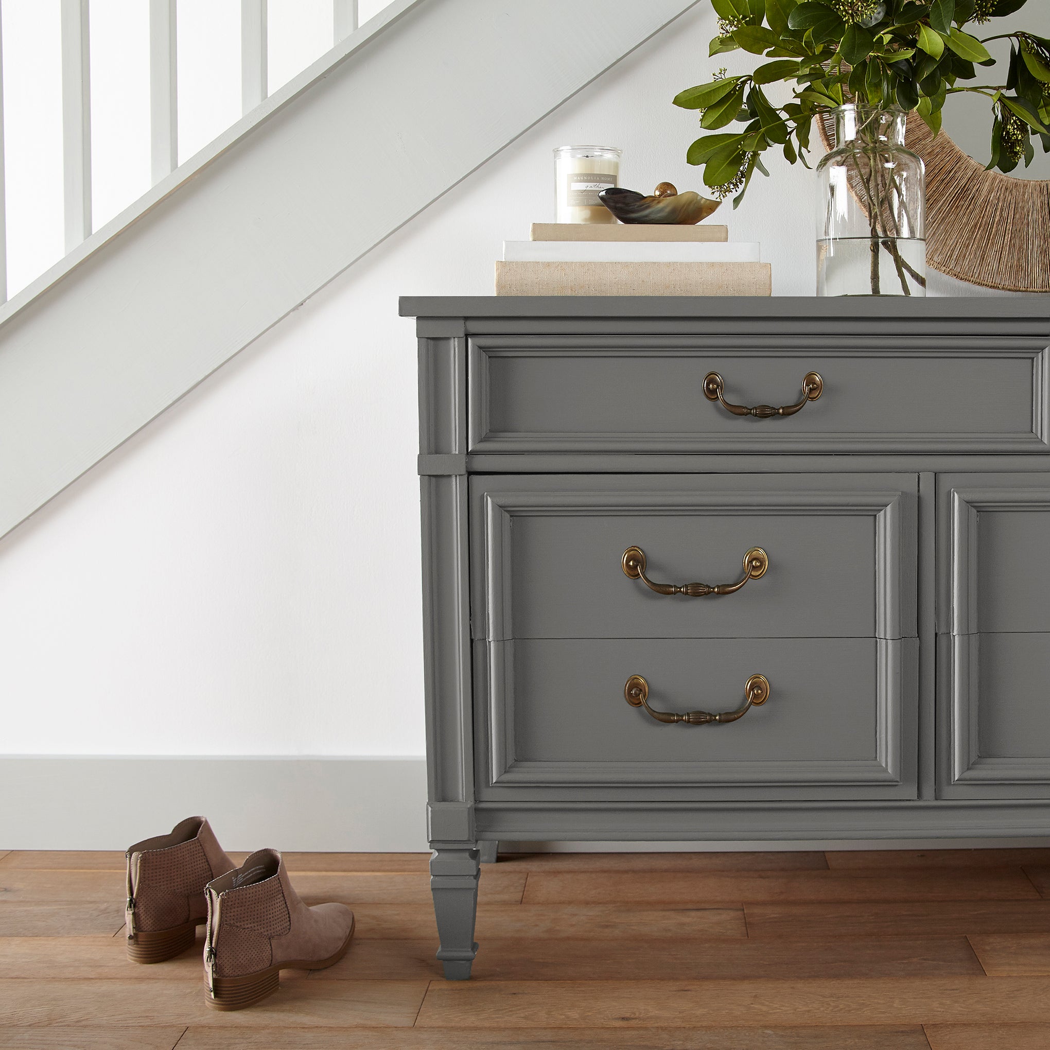 Dark gray touched brown door and cabinet paint named salvaged shown painted on entryway cabinet