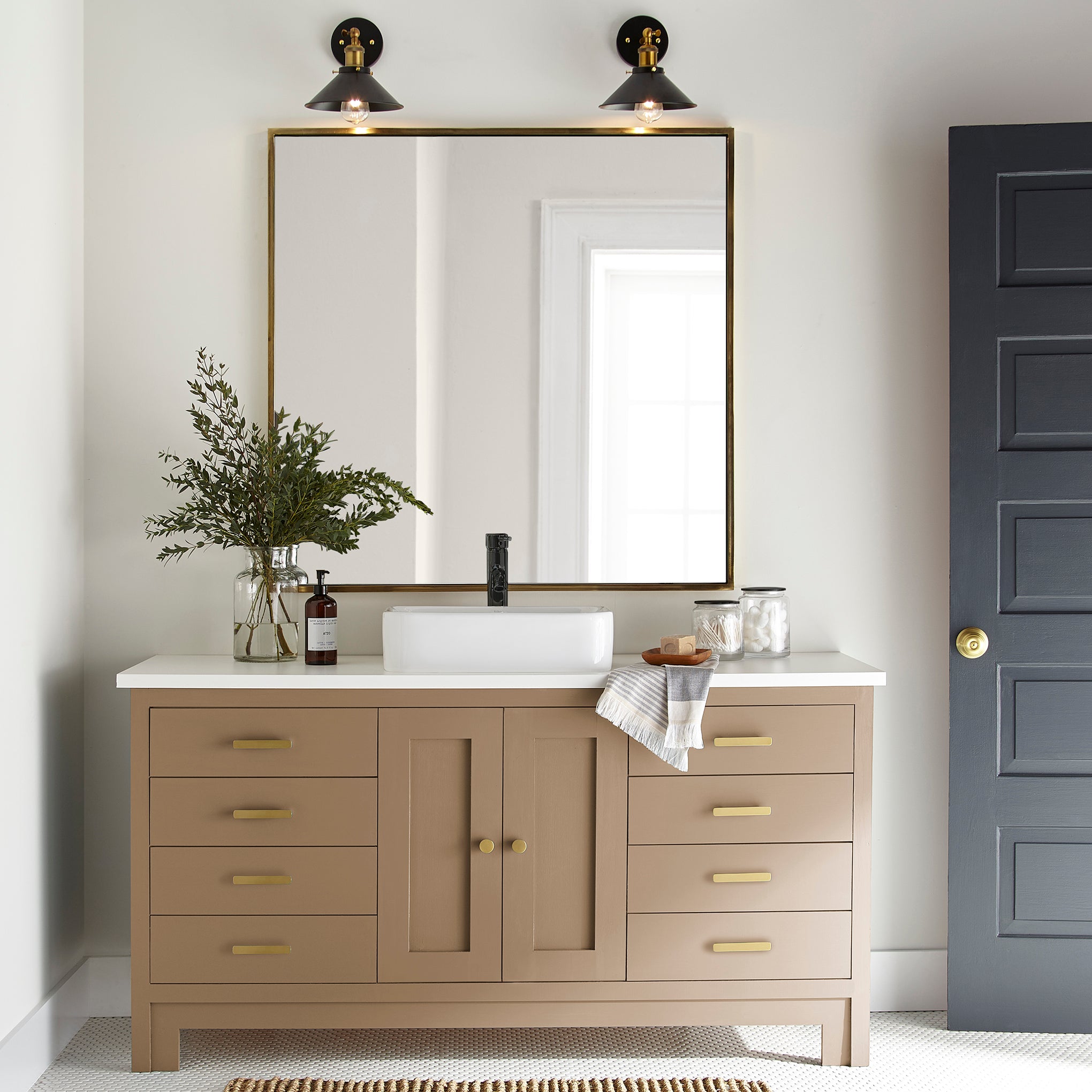 An elegant, muted gold door and cabinet paint named vintage crown shown painted on bathroom cabinet