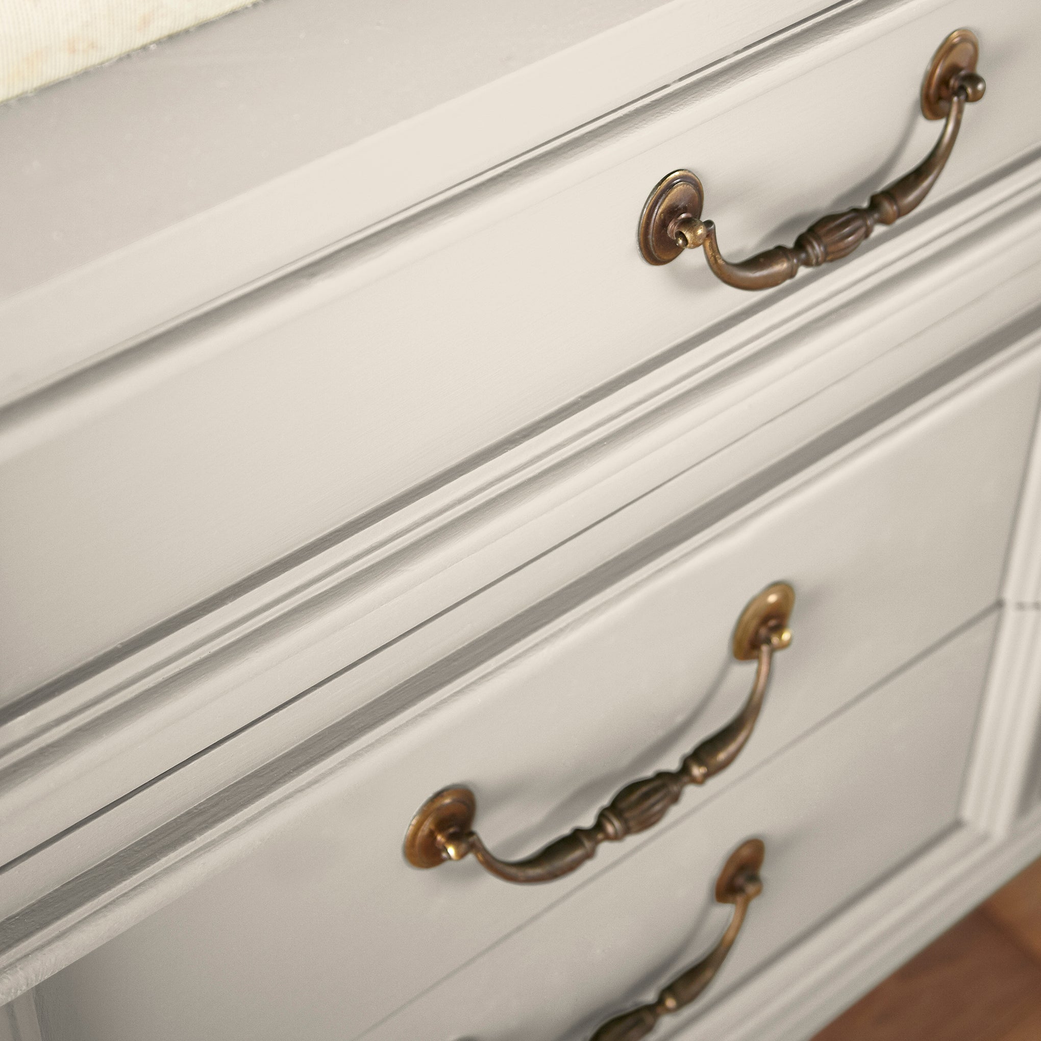 A creamy, soft white with a timeless essence door and cabinet paint named castle cream shown painted on cabinet