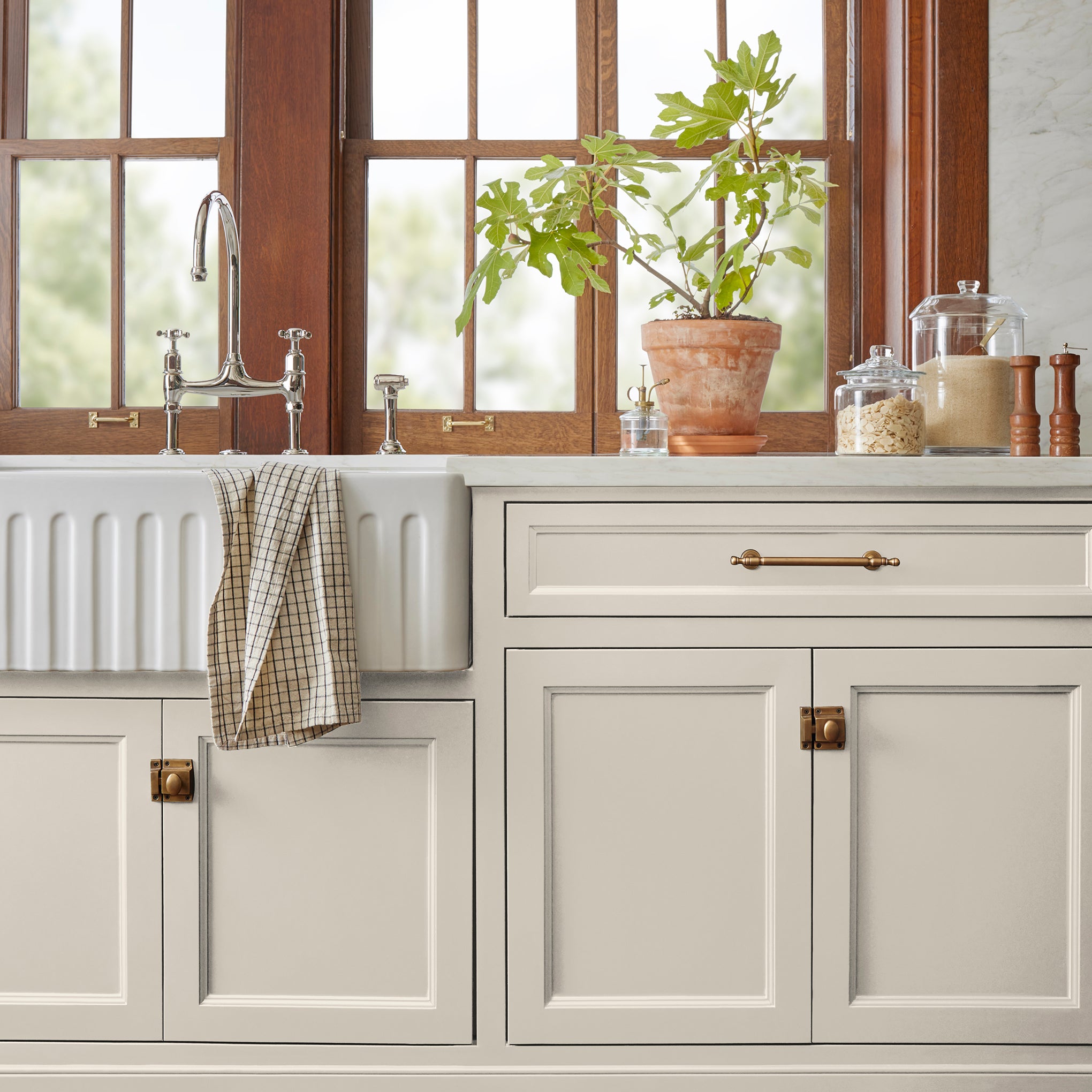 A creamy, soft white with a timeless essence door and cabinet paint named castle cream shown painted on kitchen cabinet  