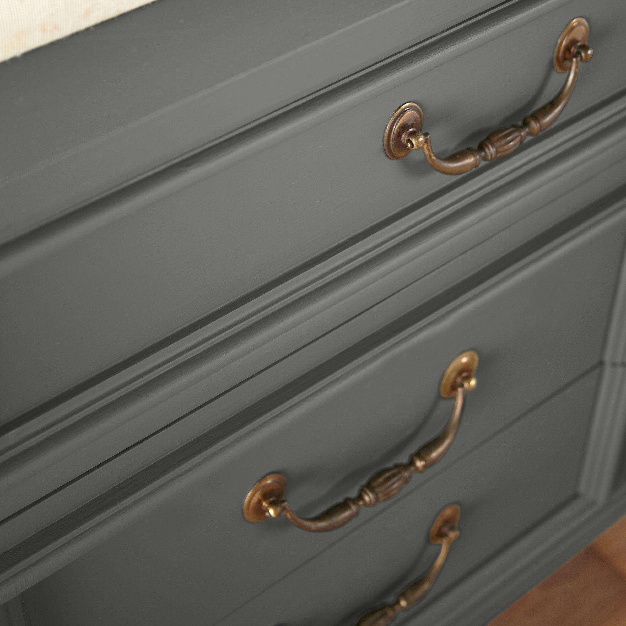 A rich and warm dark charcoal gray door and cabinet paint named conservatory shown painted on cabinet