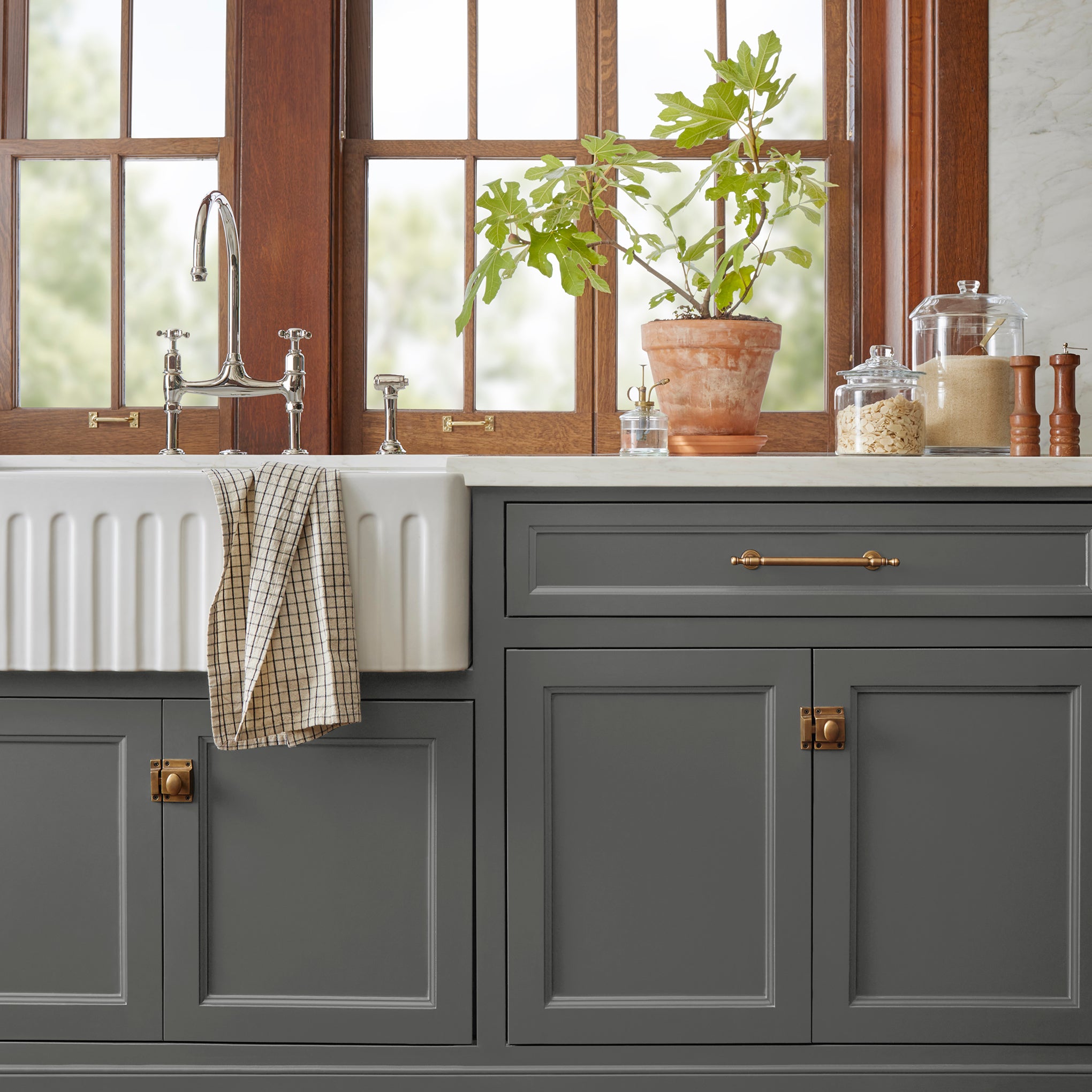 A rich and warm dark charcoal gray door and cabinet paint named conservatory shown painted on kitchen cabinet 