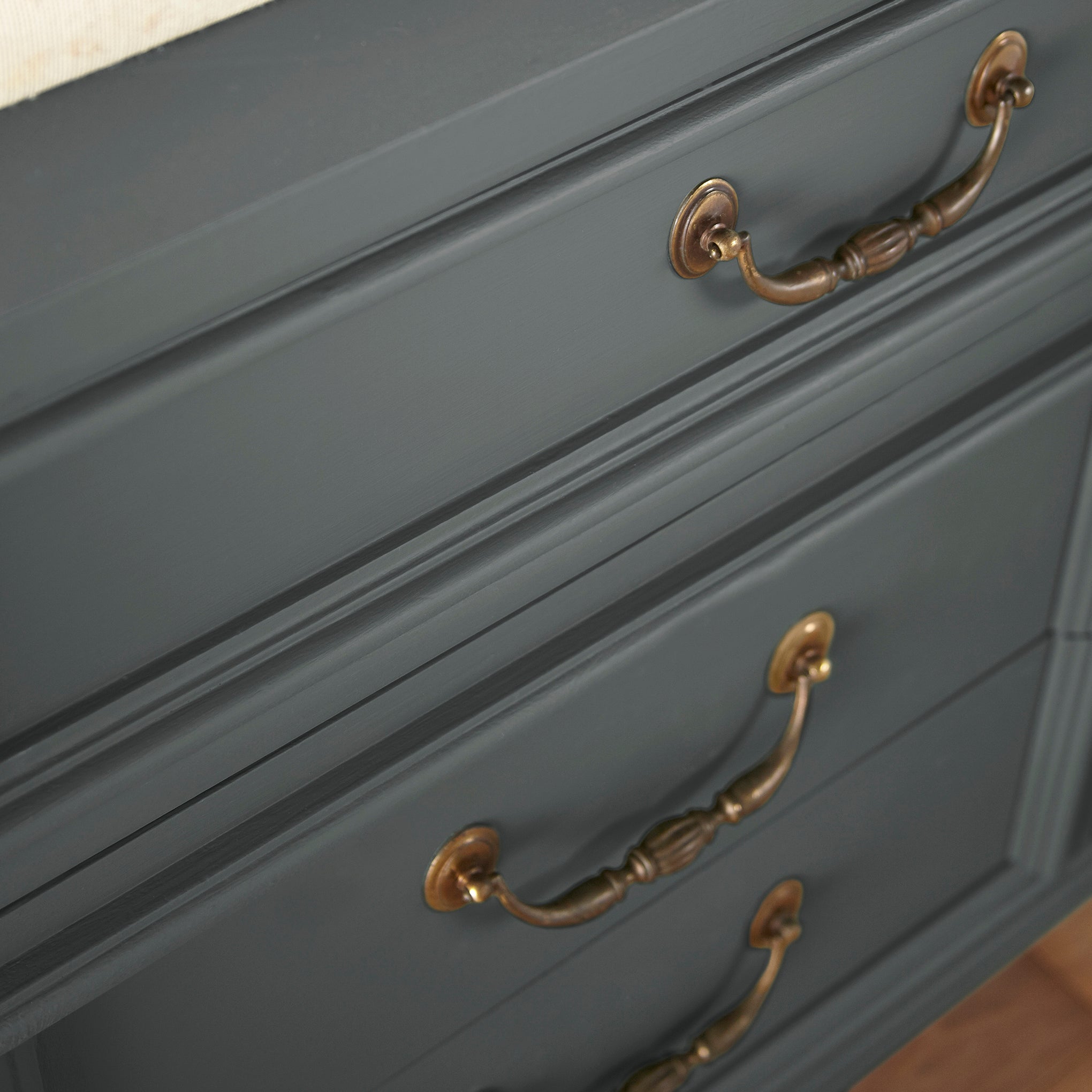 A moody navy infused with a deep green hue door and cabinet paint named cottage grove shown painted on cabinet