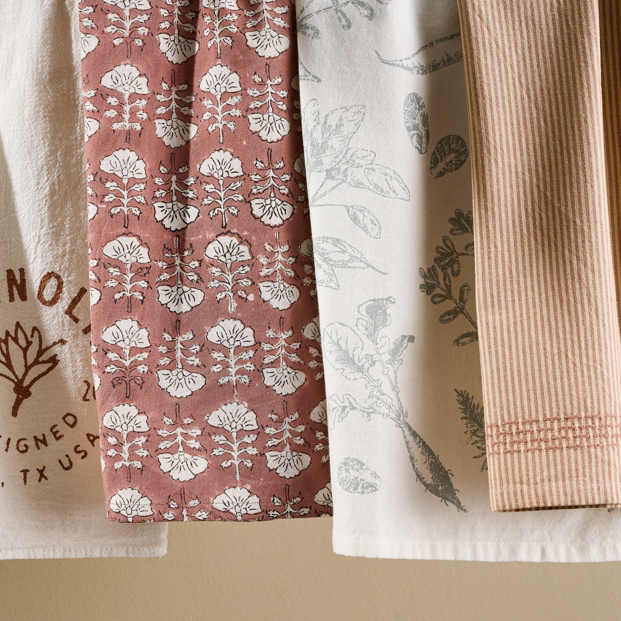 Magnoliass Veggie Print Tea Towel next to other tea towels