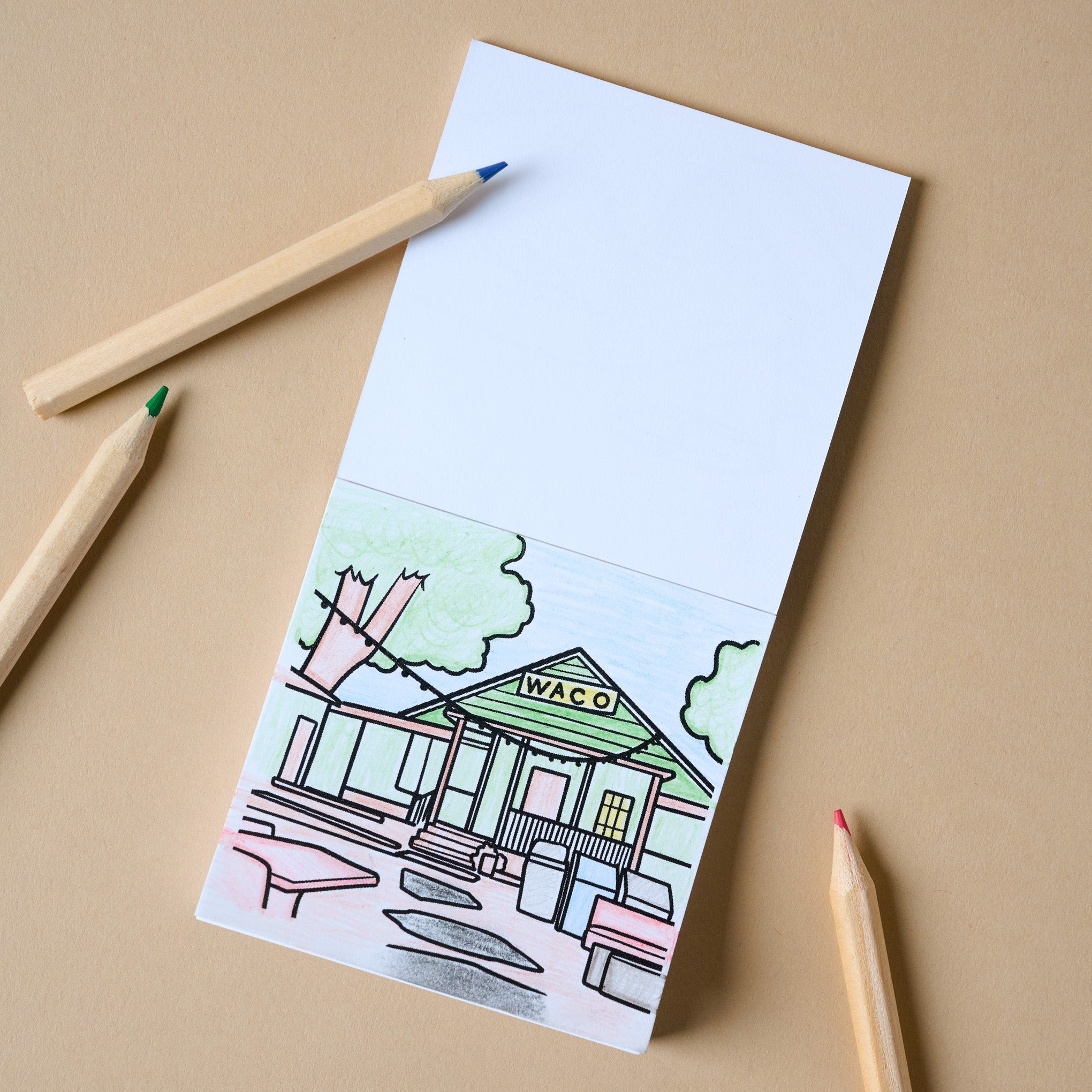 Magnoliass Mini Coloring Book open to a page with a coffee shop