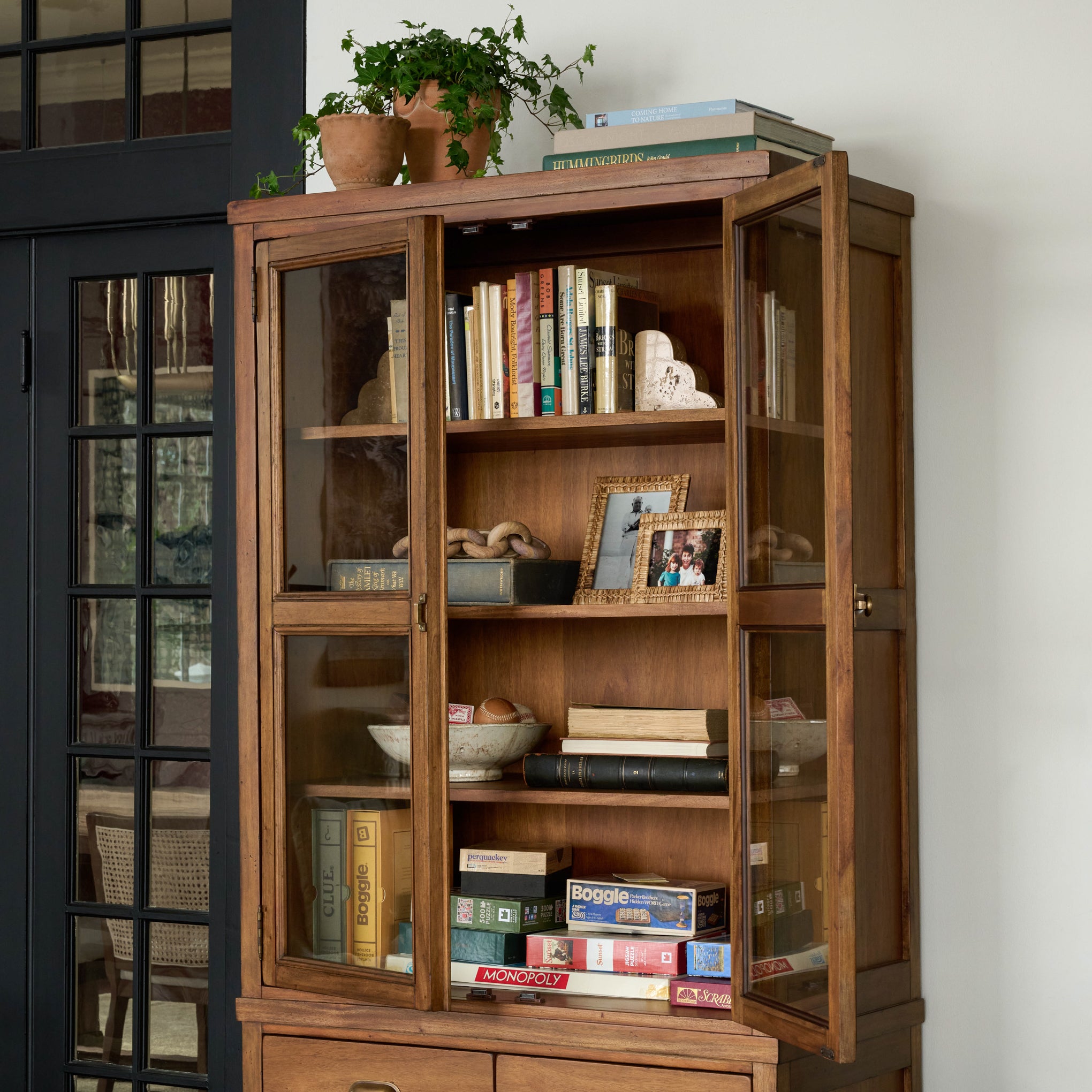 Hammond Cabinet in a room with doors open and photos, books and games inside