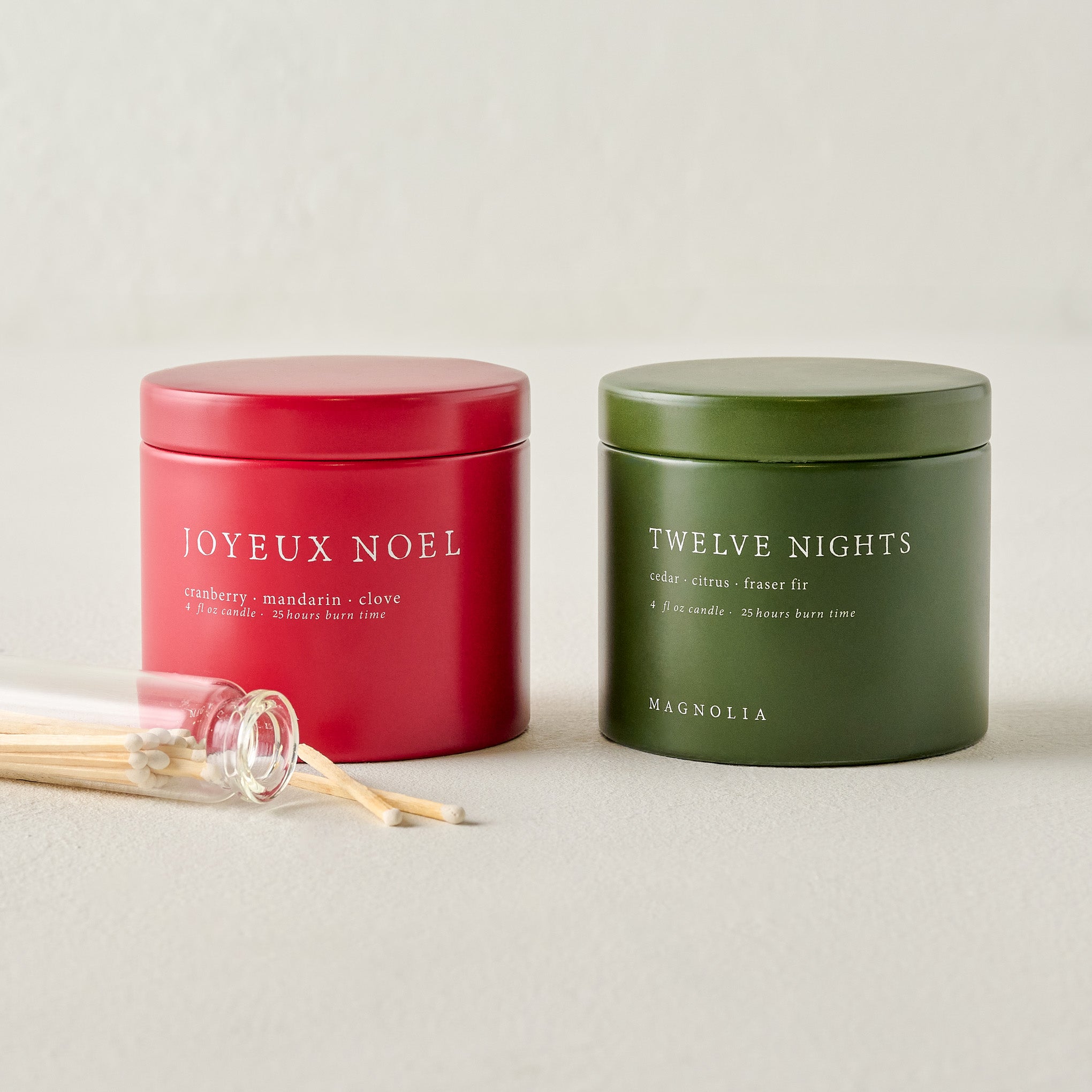 Magnoliass Joyeux Noel and Twelve Nights Candle Tin Bundle shown with matches