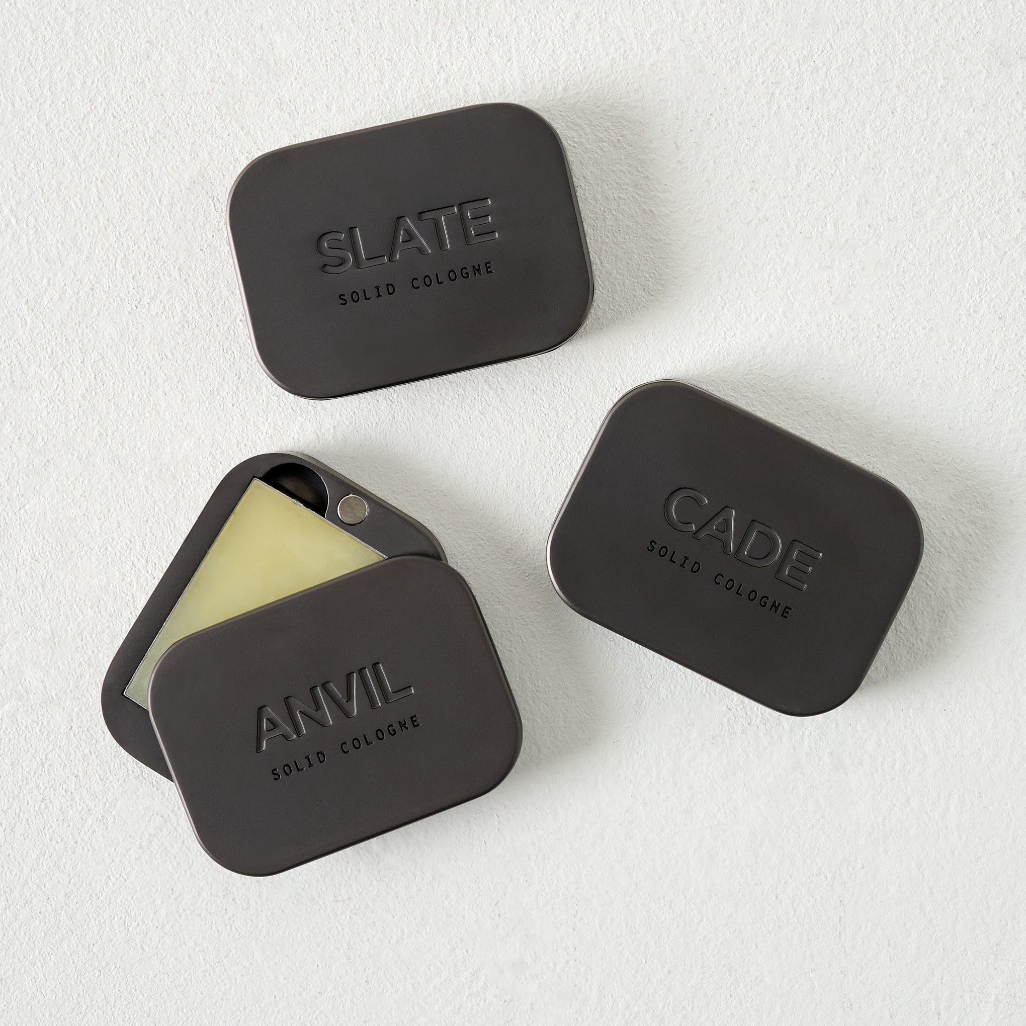 Manready Mercantile Cade Solid Cologne shown with Anvil and Slate solid cologne