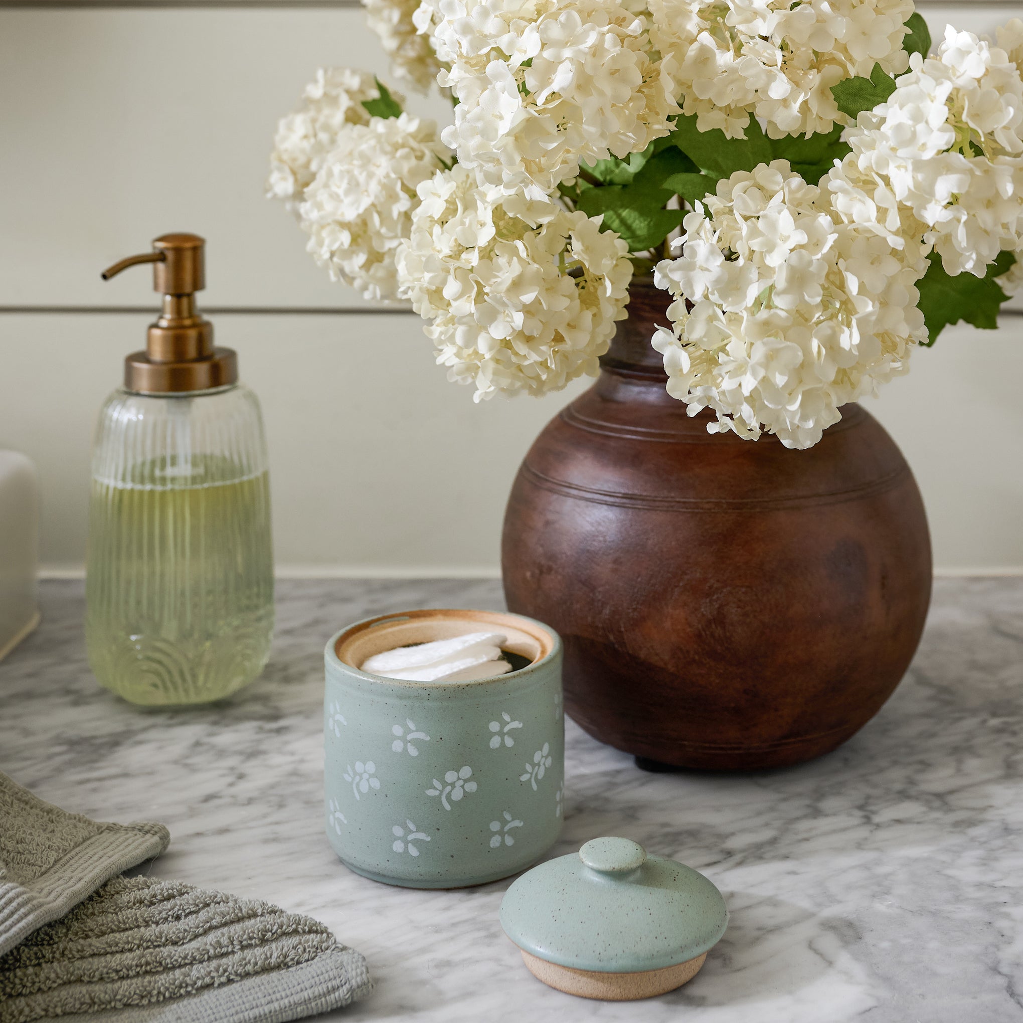 Emilie Floral Painted Canister shown on bathroom counter