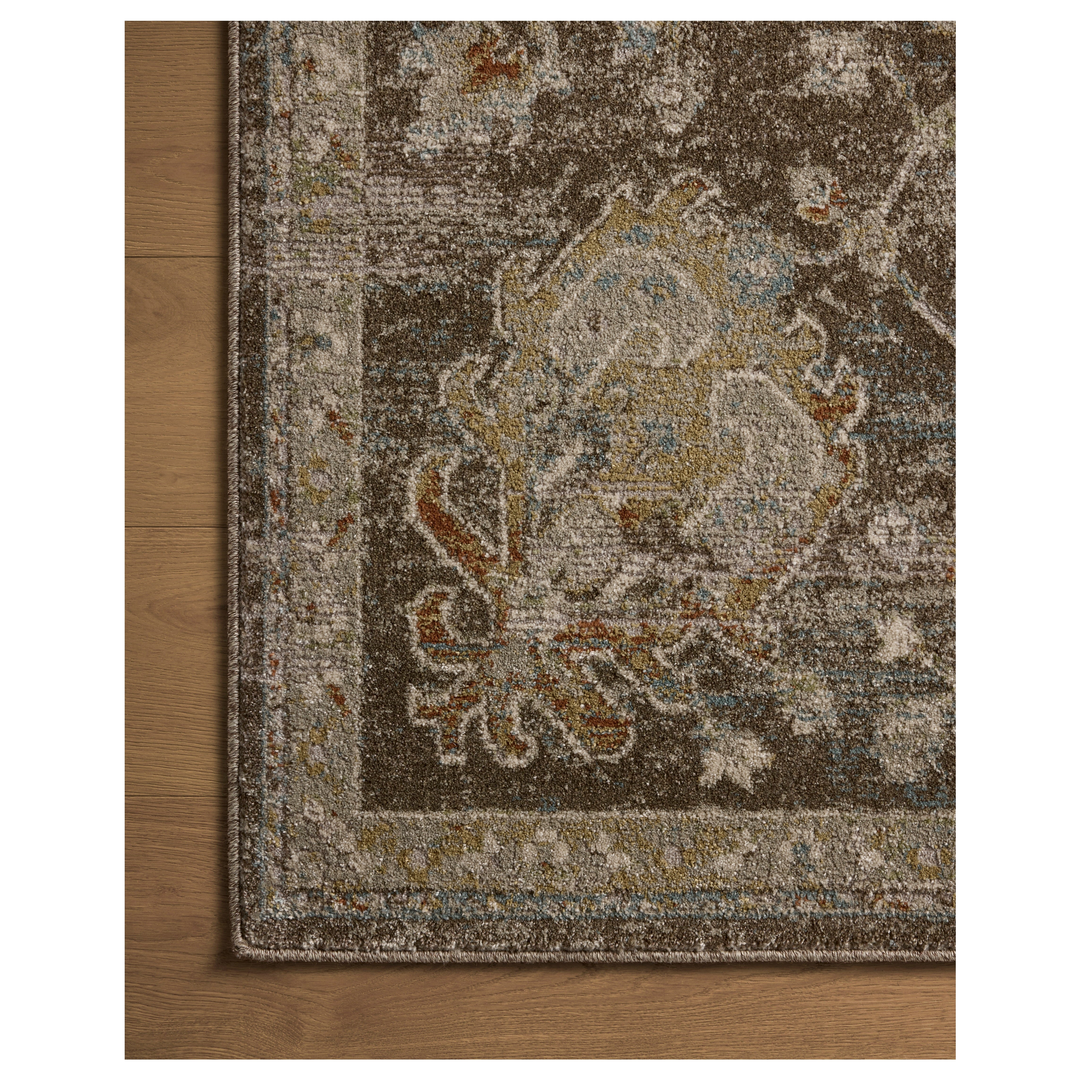 Mona Bark Multi Rug close up of corner on wood floor