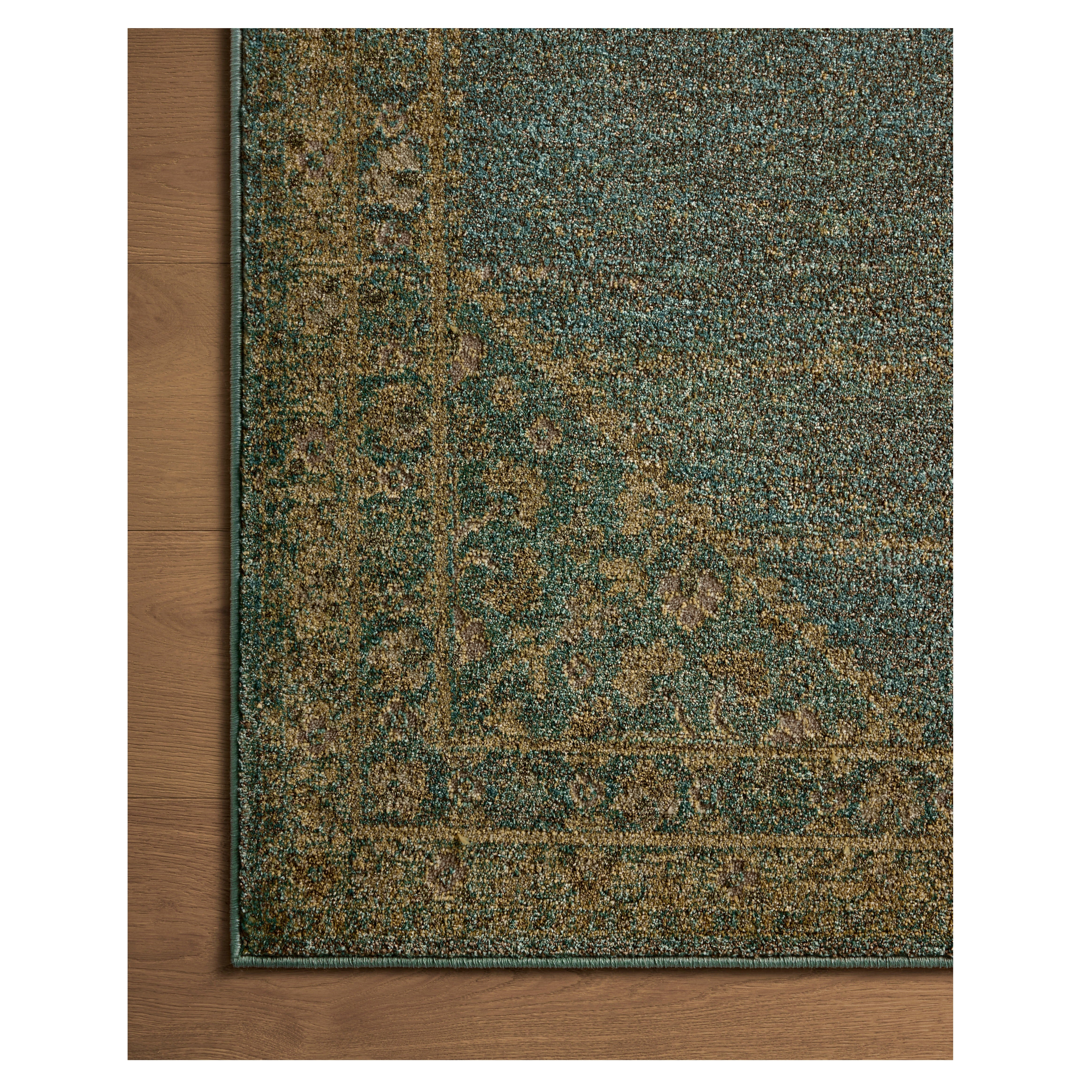 Mona Aqua Wheat Rug close up of corner on wood floor