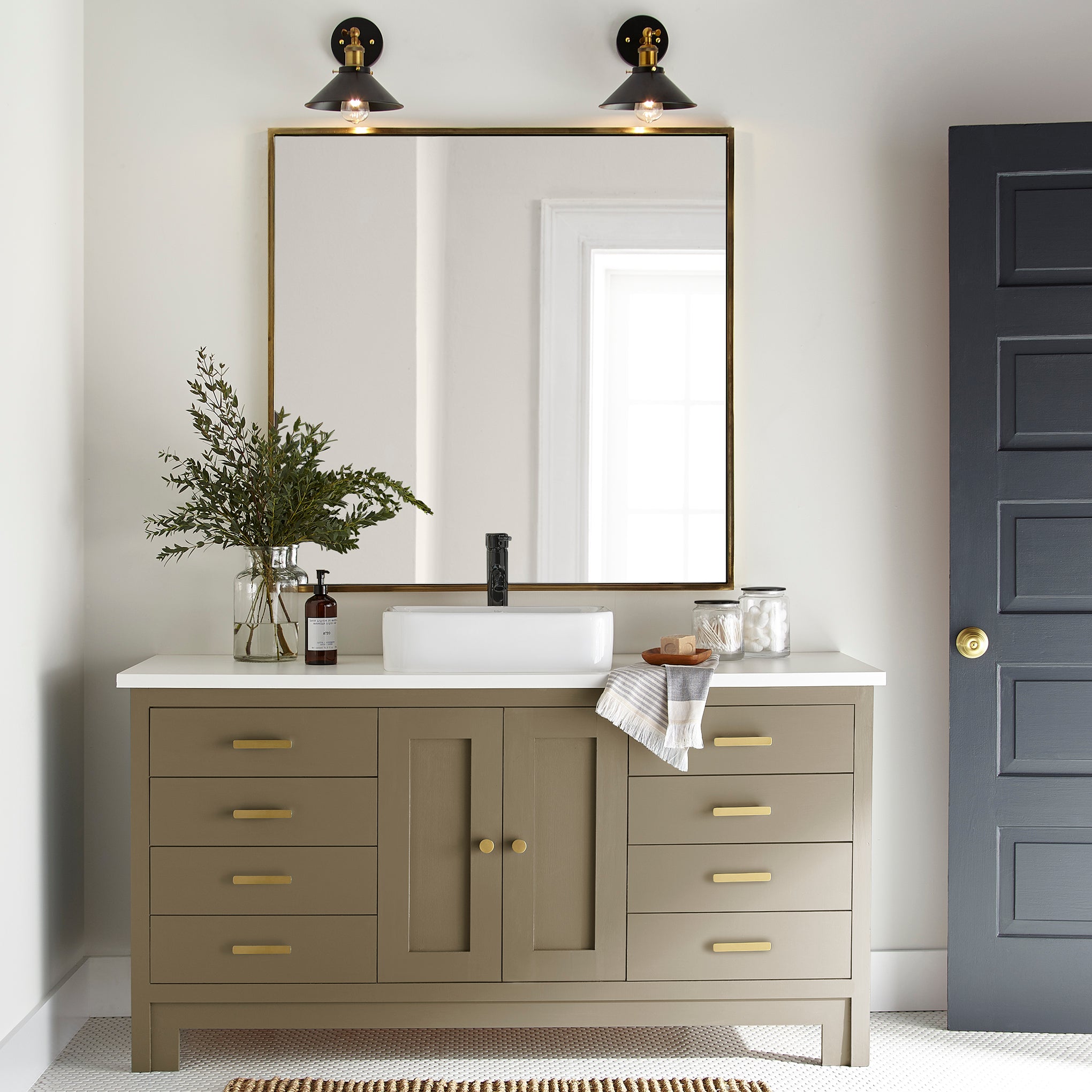 rich green with brown undertone paint color named remote trail shown painted on bathroom cabinet
