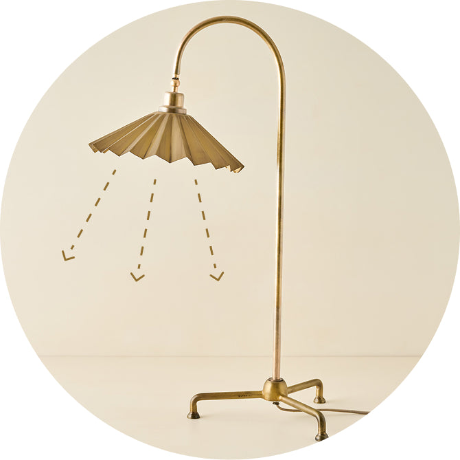 Brass shower head and faucet on a beige background