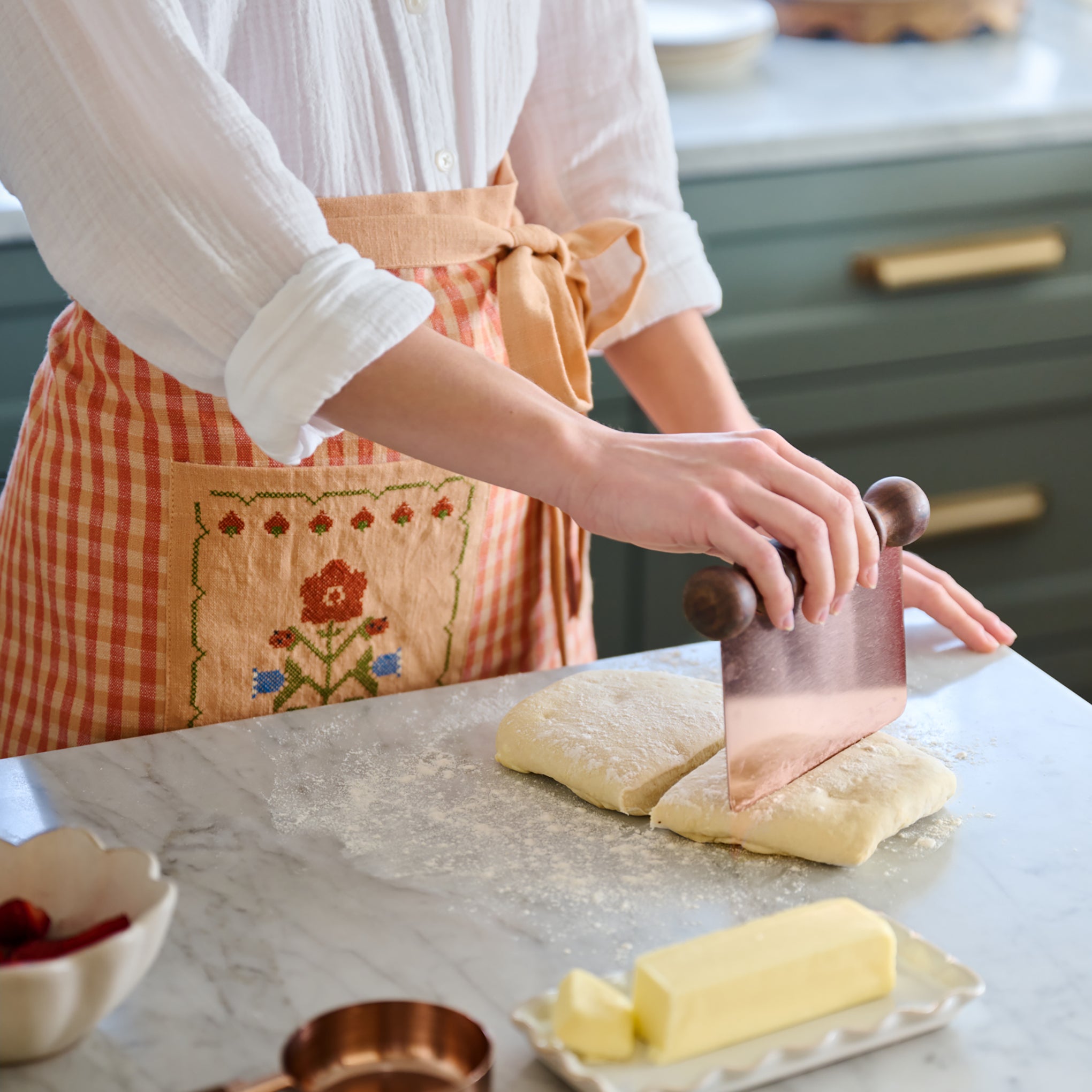 Strawberry Fields Cross Stitch Apron used in kitchen prep