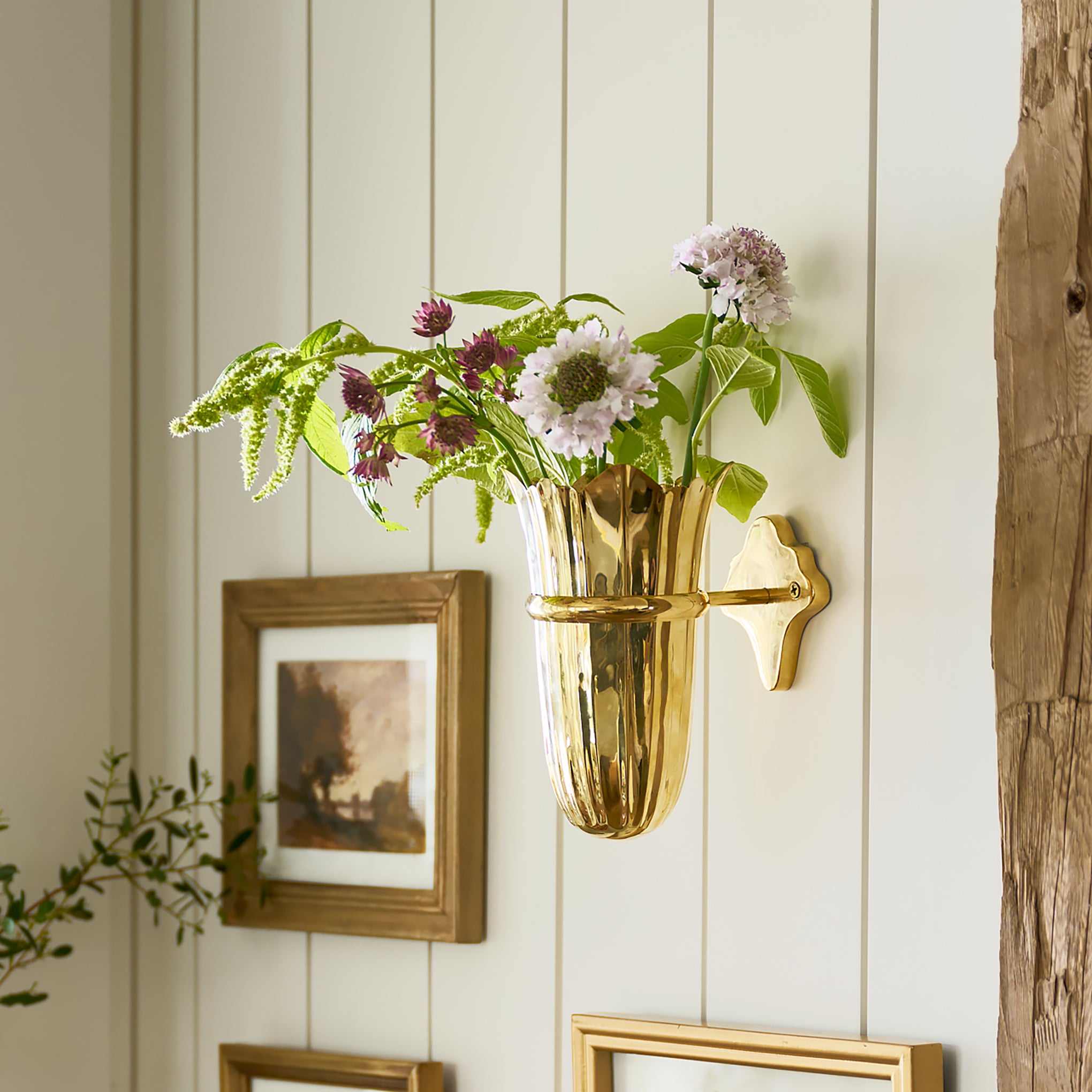 Theresa Wall Mounted Solid Brass Vase with florals inside on wall