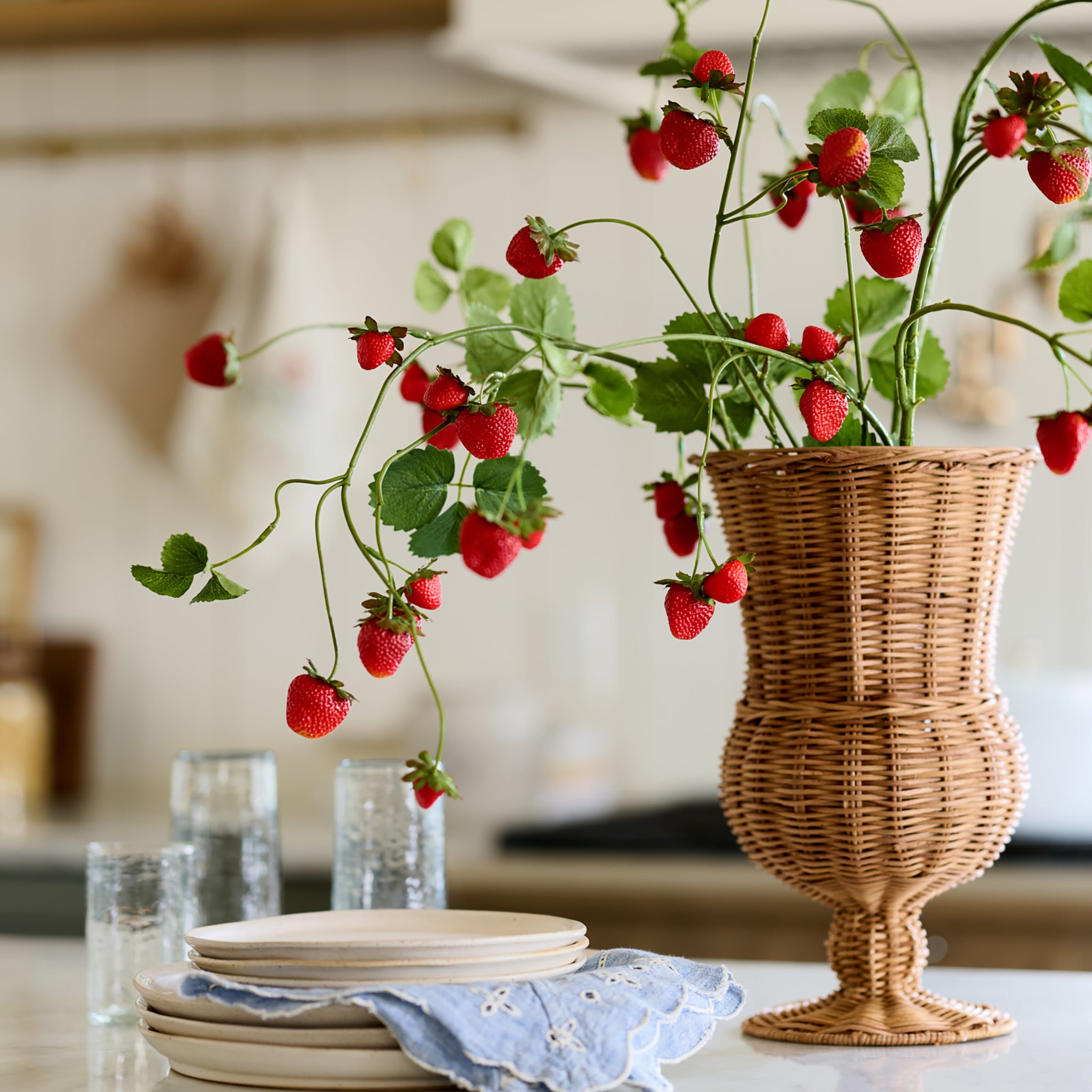 Strawberry Vine shown in rattan vase in kitchen 