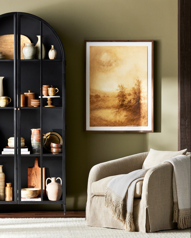 Harris Slipcovered Swivel Chair in a room next to a cabinet