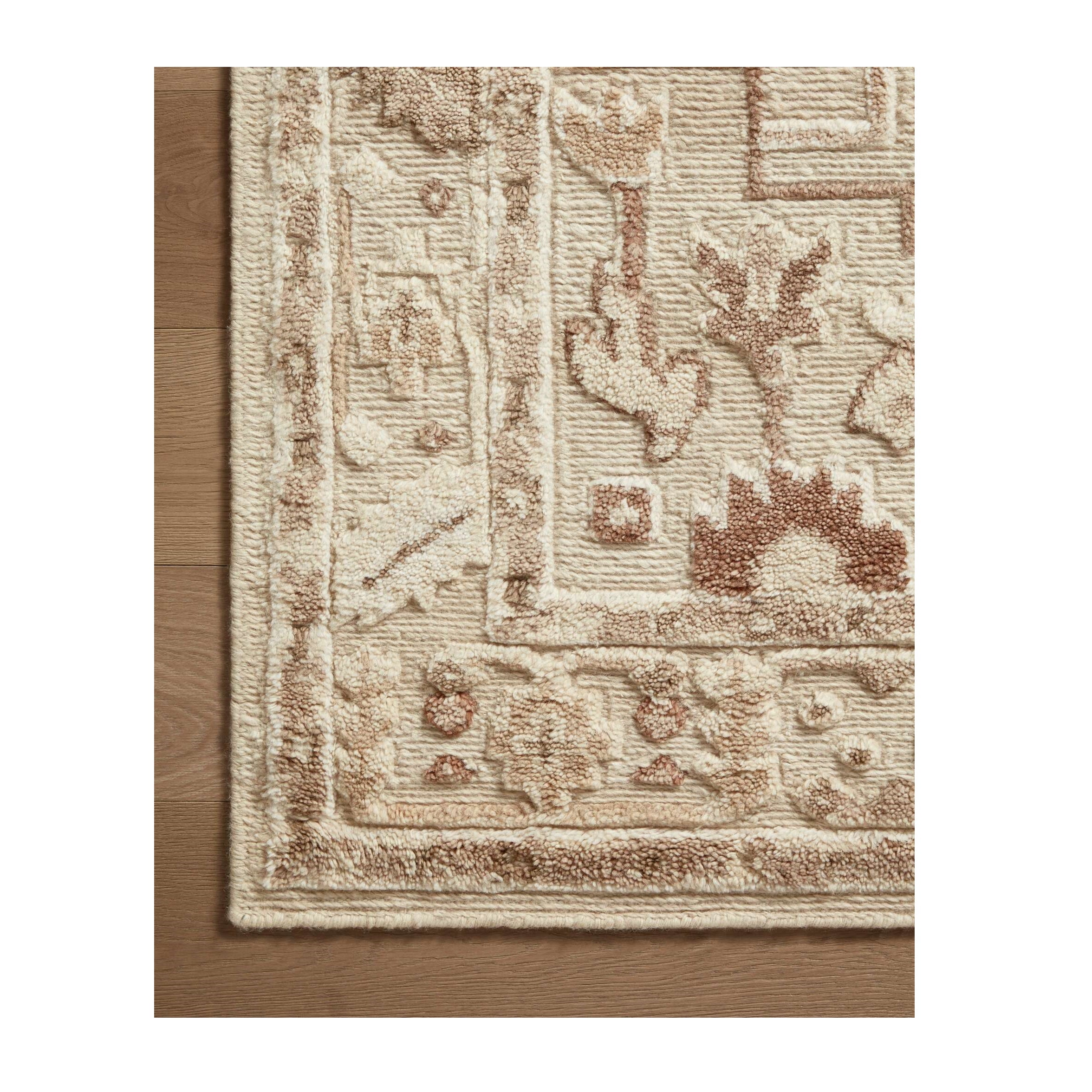 Ingrid Ivory Earth Rug close up of corner on wood floor