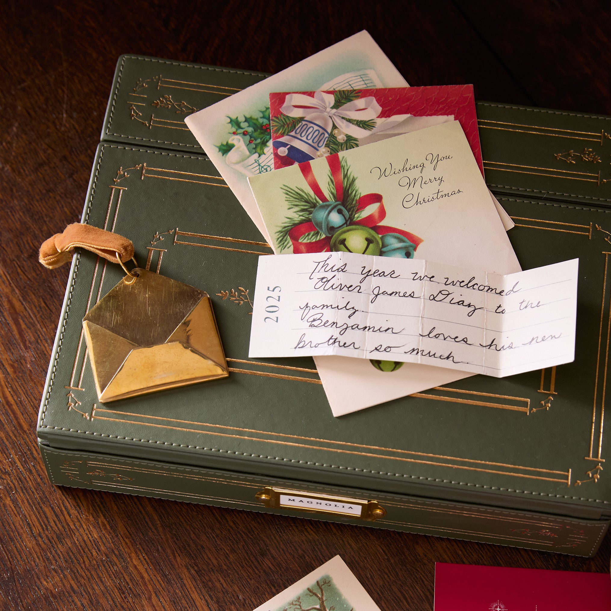 2025 Magnoliass Brass Keepsake Envelope Ornament in use