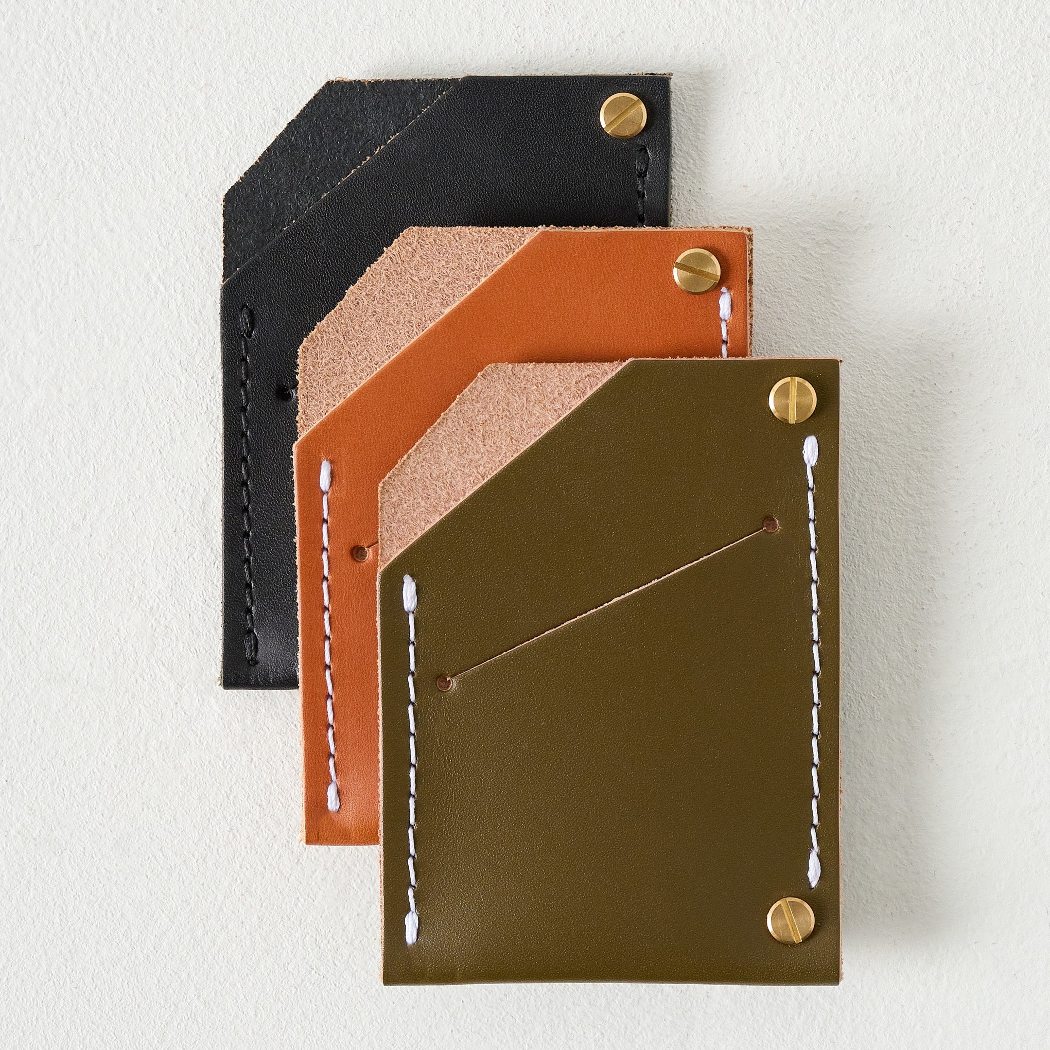 Olive Quebec Wallet shown with other wallets