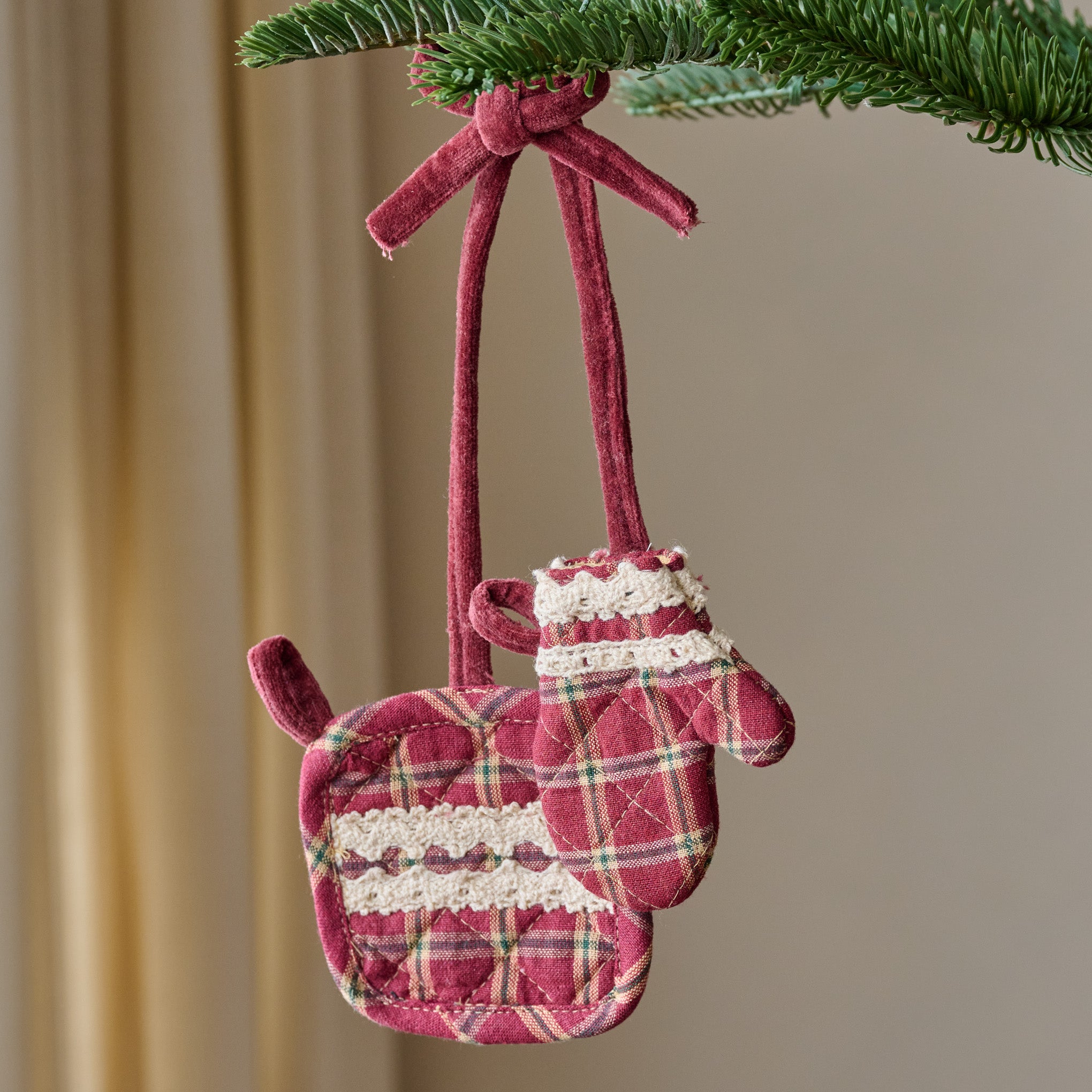 Magnoliass Red Plaid Oven Mit + Pot Holder Ornament shown hung from branch