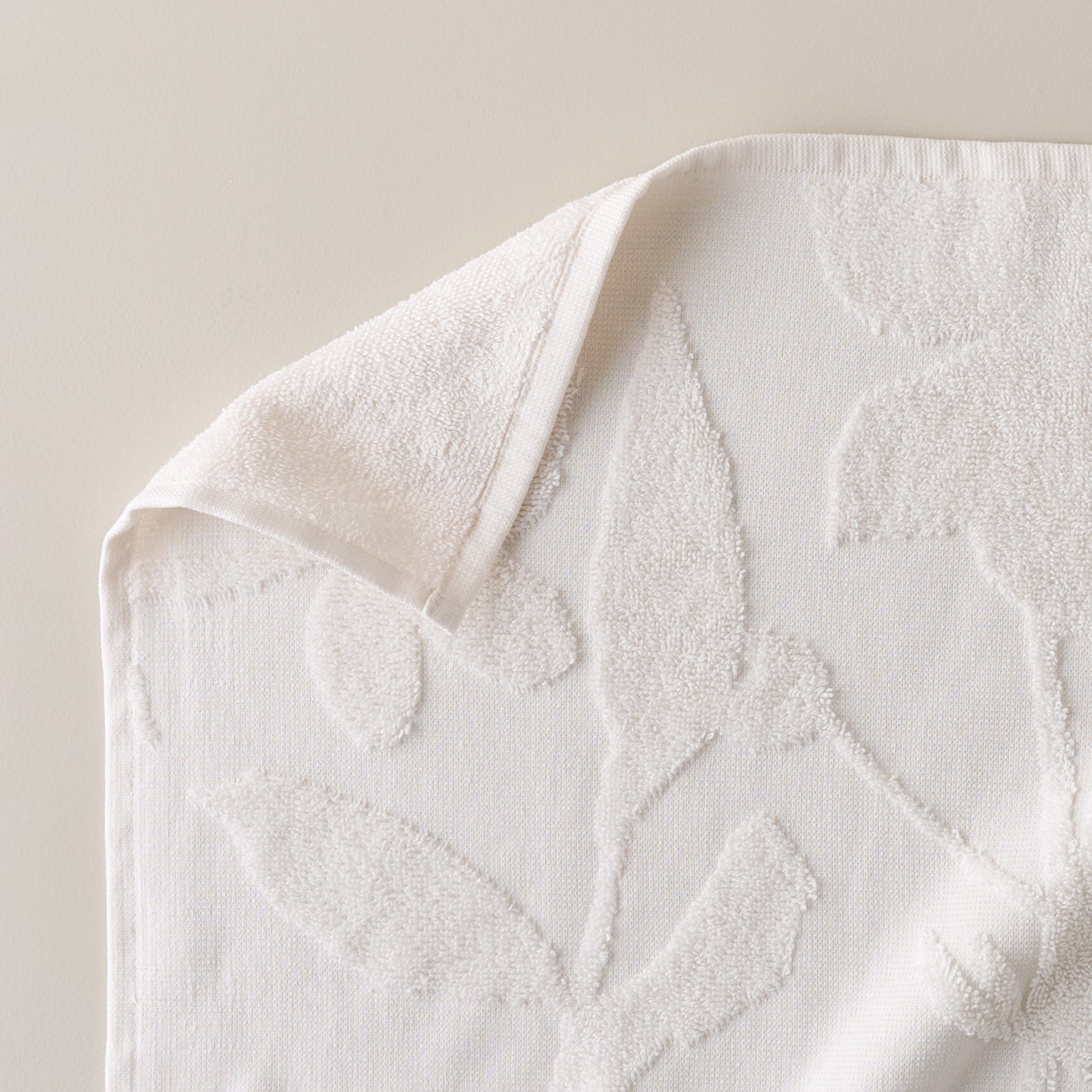 Snow White Floral Jacquard Towel corner up close shown folded