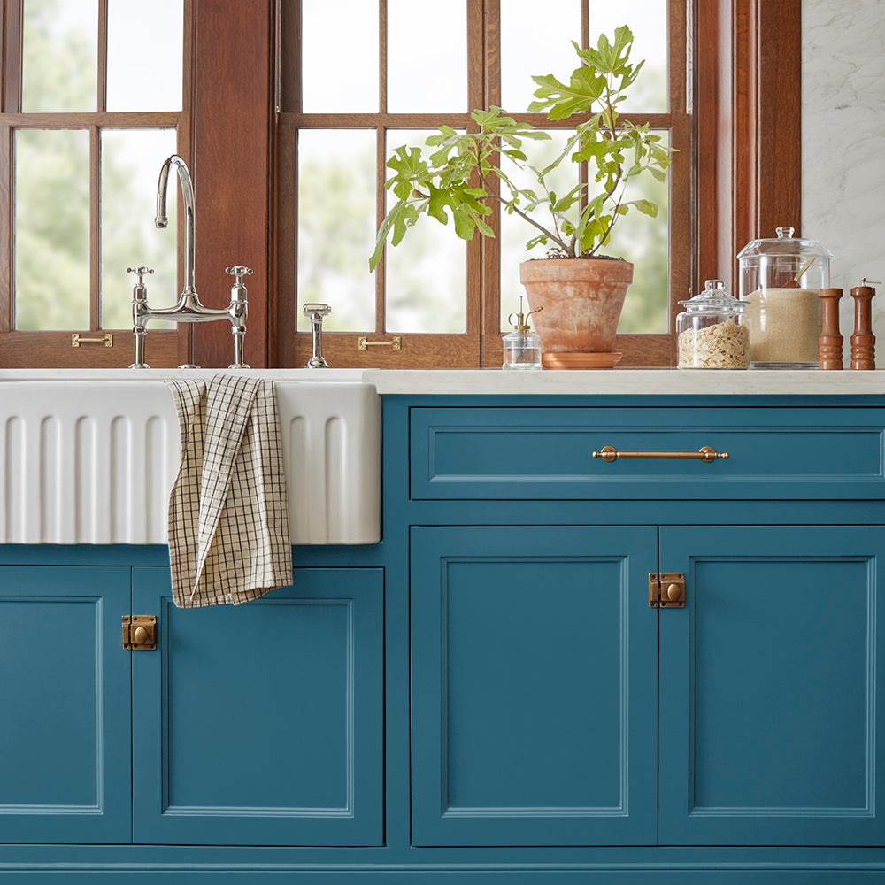 true blue paint color named superior shown painted on kitchen cabinets