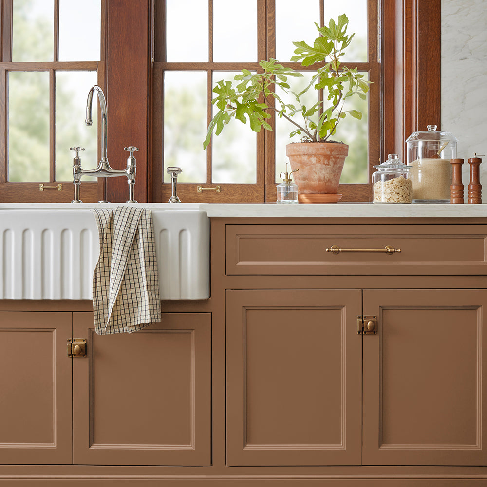 earthy brown with reddish hue paint color named cognac shown painted on kitchen cabinets